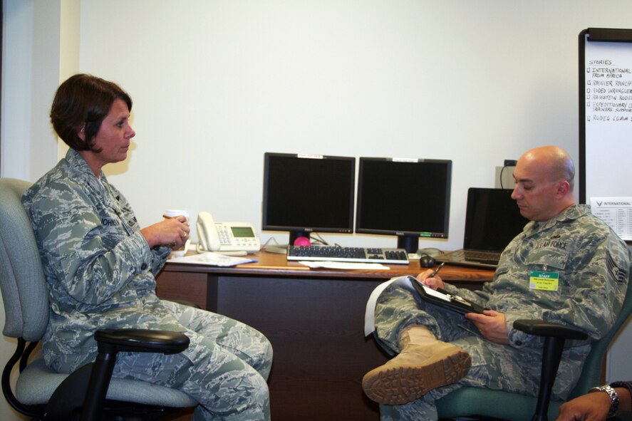 Col. Beverly Johnson, chief of aeromedical evacuation at Air Mobility Command Headquarters at Scott Air Force Base, Ill., stops for an interview with Staff Sgt. J.G. Buzanowski, public affairs craftsman, at Joint Base Lewis-McChord, Wash., on July 18, 2011. Johnson is one of the lead people in charge of the 2011 International Aeromedical Evacuation/En Route Care Conference. (U.S. Air Force Photo/Master Sgt. Scott T. Sturkol)