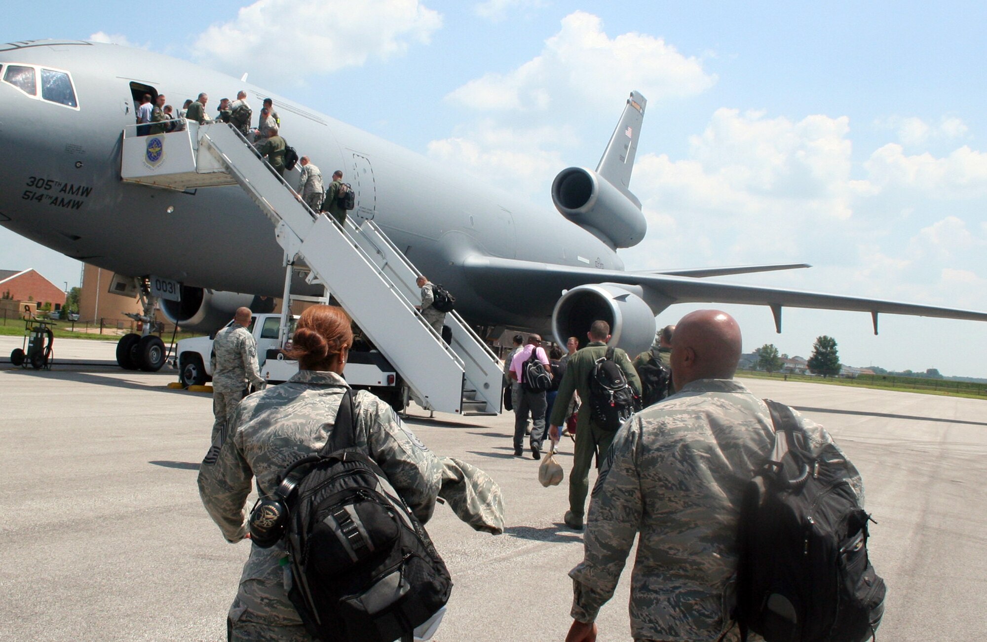 Personnel board a KC-10 Extender for a mission at Scott Air Force Base, Ill., on July 17, 2011. The KC-10, from the 305th Air Mobility Wing of Joint Base McGuire-Dix-Lakehurst, N.J., flew staff members supporting Air Mobility Rodeo 2011 from Scott AFB to Joint Base Lewis-McChord, Wash. Air Mobility Rodeo is the U.S. Air Force's and Air Mobility Command's premier international combat skills and flying operations competition designed to develop and improve techniques, procedures and interoperability, while optimizing international mobility partnerships and enhancing mobility operations. (U.S. Air Force Photo/Master Sgt. Scott T. Sturkol)
