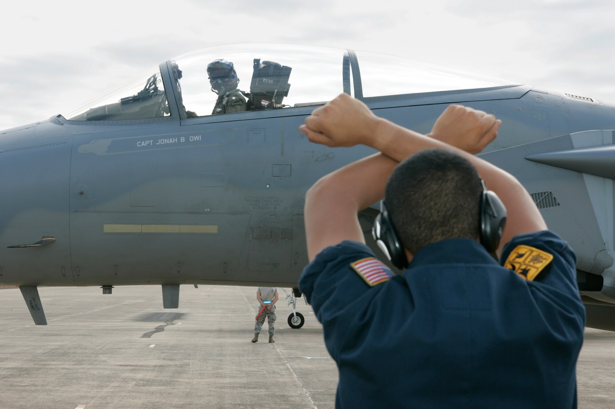 United States Air Force 18th Maintenance Squadron Crew Chief, Airman First Class Orlando Nastacio, marshals a F-15C Eagle back onto the flight line after a sortie during the buildup to Exercise Talisman.Mid Caption: RAAF Base Darwin is hosting six F-15C Eagle fighter jets from the United States Air Force?s 44th Fighter Squadron for Exercise Talisman Sabre 2011. The Eagles, based at Kadena Air Base in Okinawa, Japan, are being supported by technicians from the 18th Maintenance Squadron, also from Kadena. These aircraft are conducting missions over training areas in the Northern Territory with a mix of United States Air Force, Navy, and Royal Australian Air Force aircraft.