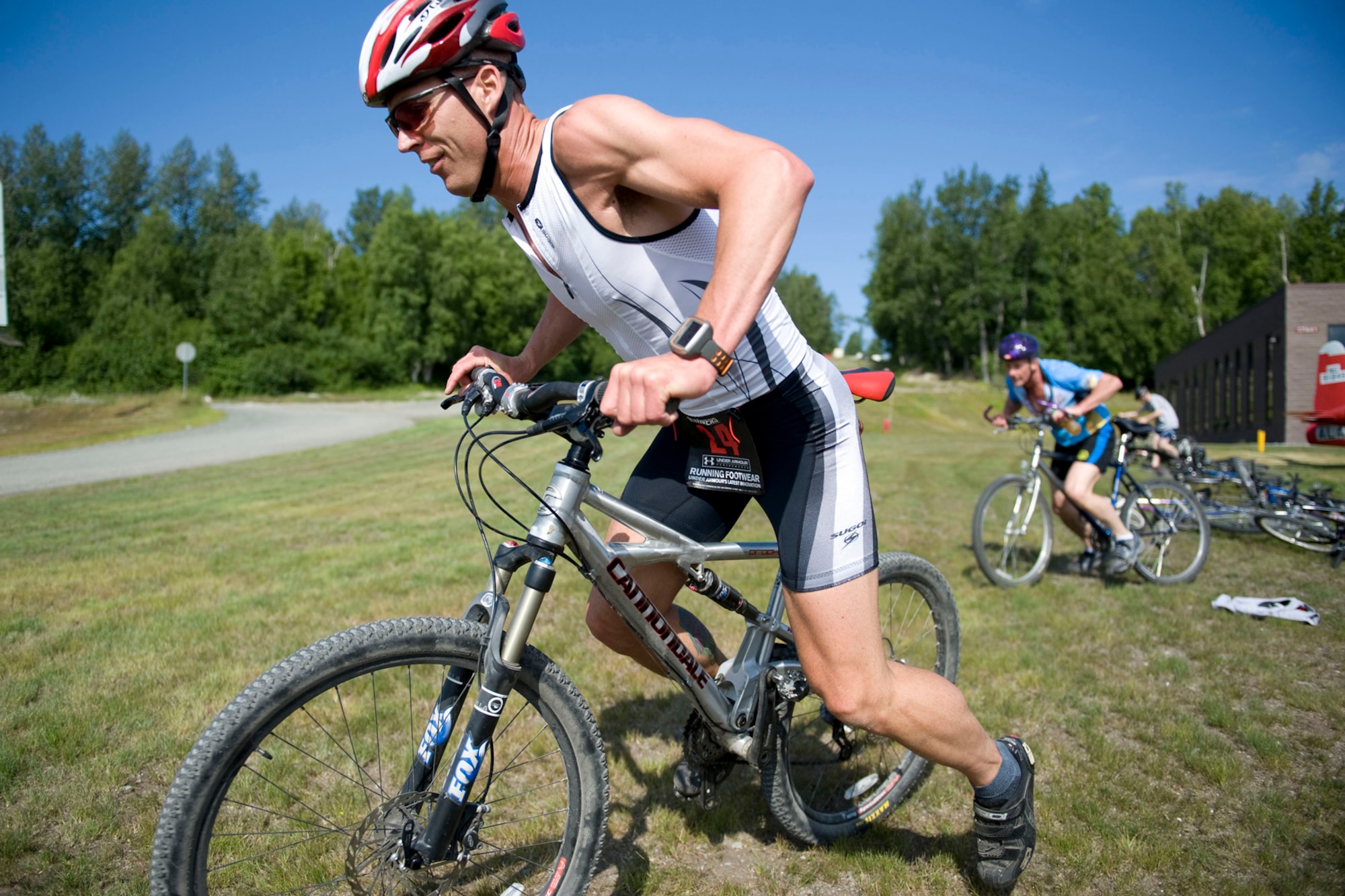 JOINT BASE ELMENDORF-RICHARDSON, Alaska - Capt. Shane Garling with the 176th Aircraft Maintenance Squadron, takes off for the bike riding portion of the 176th Wing's duathlon, July 16, 2001. The duathlon was created to help encourage a culture of fitness and esprit de corps within the wing and was sponsored by the Kulis Senior Enlisted Association. The event kicked off the "Kulis Family" Block Picnic, an annual wing get-together with co-workers and family. The course was roughly a 1.5 mile run, five mile bike ride and then a mile run to finish. Alaska Air National Guard photo by Master Sgt. Shannon Oleson