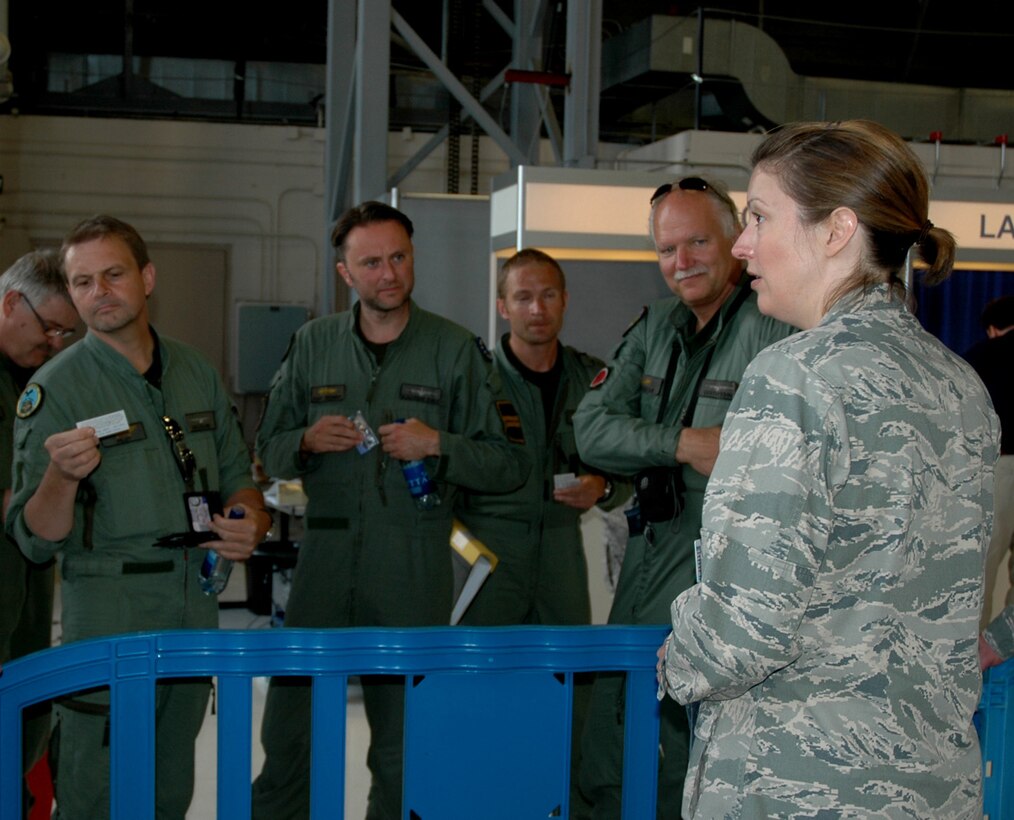 Maj. Ginger Ormond, 446th Maintenance Group, right, talks to the team from Sweden after their arrival at McChord Field, Wash.,  July 18 for Air Mobility Rodeo.  The team from Sweden, flying a C-130, will be competing during the Rodeo Competition July 24-30. Reservists from the 446th Maintenance Group are hosting the team from Sweden during their stay. (U.S. Air Force photo by Sandra Pishner)
