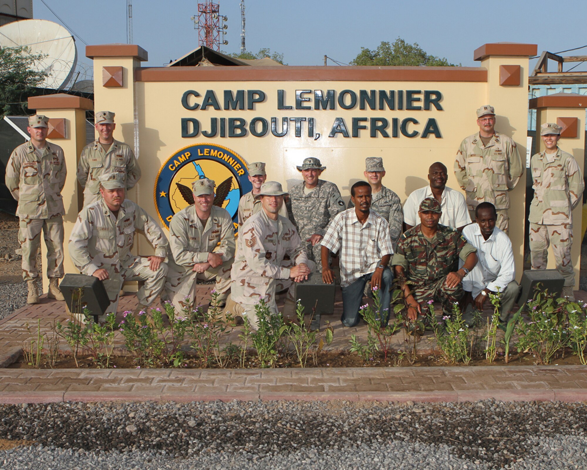 From left, AEDC's Capt. Jeffery Hartberger, Cmdr. Steve Sims, BUC Guy Routt, CEC Chuck Coffin, Lt. J.G. Matt Manskar, Tech. Sgt. Jay Taylor, 1st Lt. Ike Bradlich, Abdullah Hassanale, Master Sgt. Michael Cook, Comoran Task Force Liaison Officer Lt. Moudjadin, Ayo, Abdi, Lt. John Mietus and Capt. Elena Mares pose for a group photo at Camp Lemonnier at Djibouti, Africa. Captain Hartberger spent 11 months deployed with Combined Joint Task Force - Horn of Africa (CJTF HOA) of the United States African Command (AFRICOM) as the Seabee project manager on the construction of schools, clinics and various military projects. Hassanale, Ayo and Abdi were the team’s translators. Captain Hartberger’s deployment took him to nine countries in East Africa. (Photo provided)