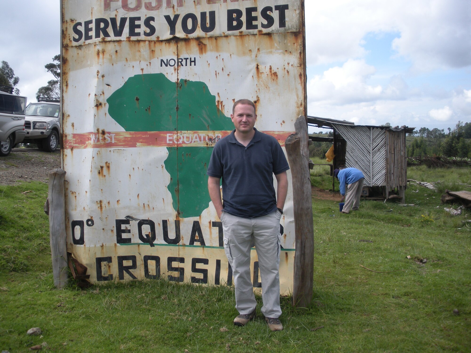 Capt. Jeffery Hartberger stands next to a sign in Kenya, northwest of Nairobi that denotes that this location is at the equator.  (Photo provided)