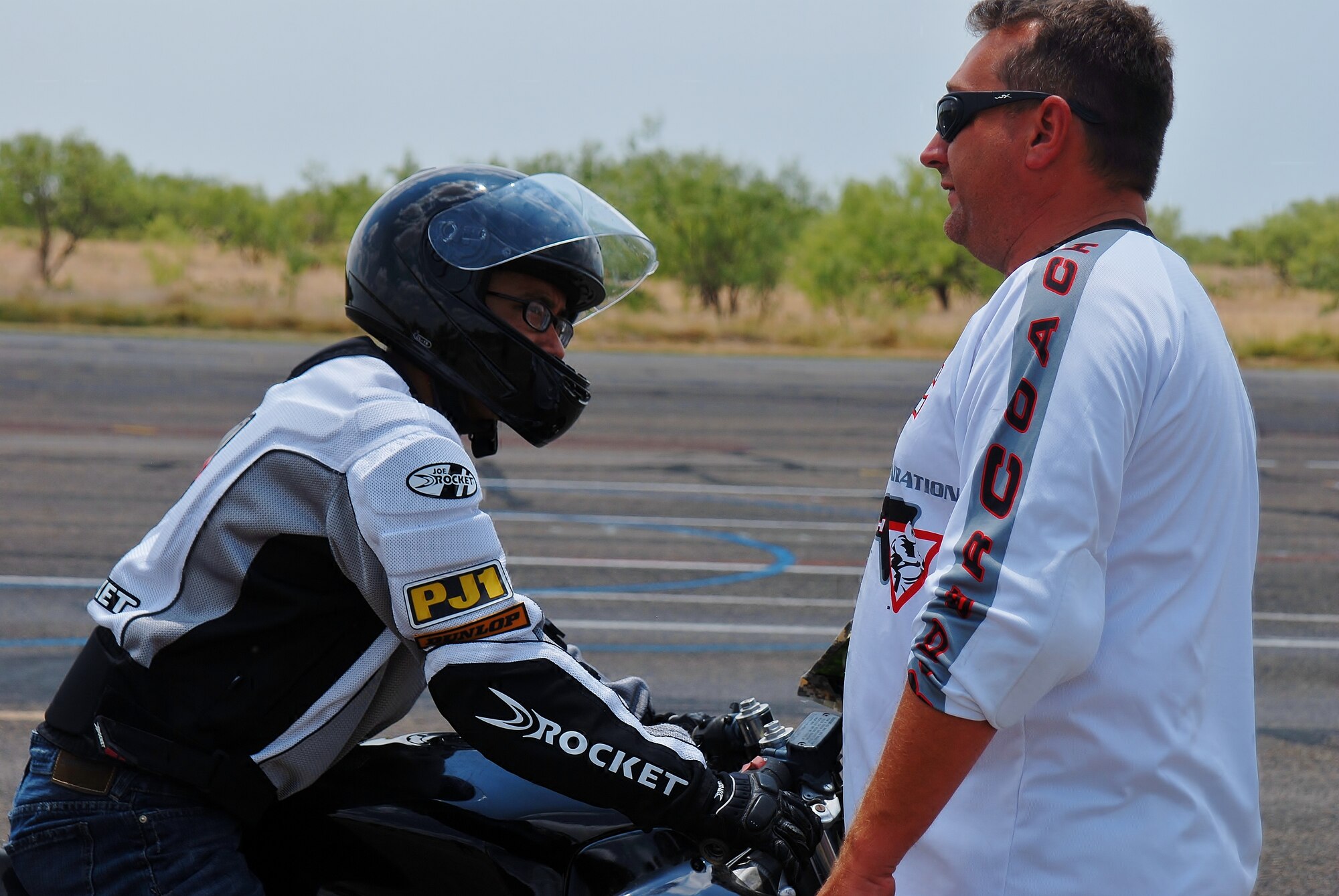 GOODFELLOW AIR FORCE BASE, Texas-- Senior Airman Mark Simbulan, 17th Training Wing Legal Office, receives instructions to help his turning posture from Steve Inscore, sports bike riding instructor, on the old flightline here July 16. The sports bike riding course is used to teach riders to be comfortable on their vehicles in adverse situations. (U.S. Air Force photo/ Airman 1st Class Michael Smith)