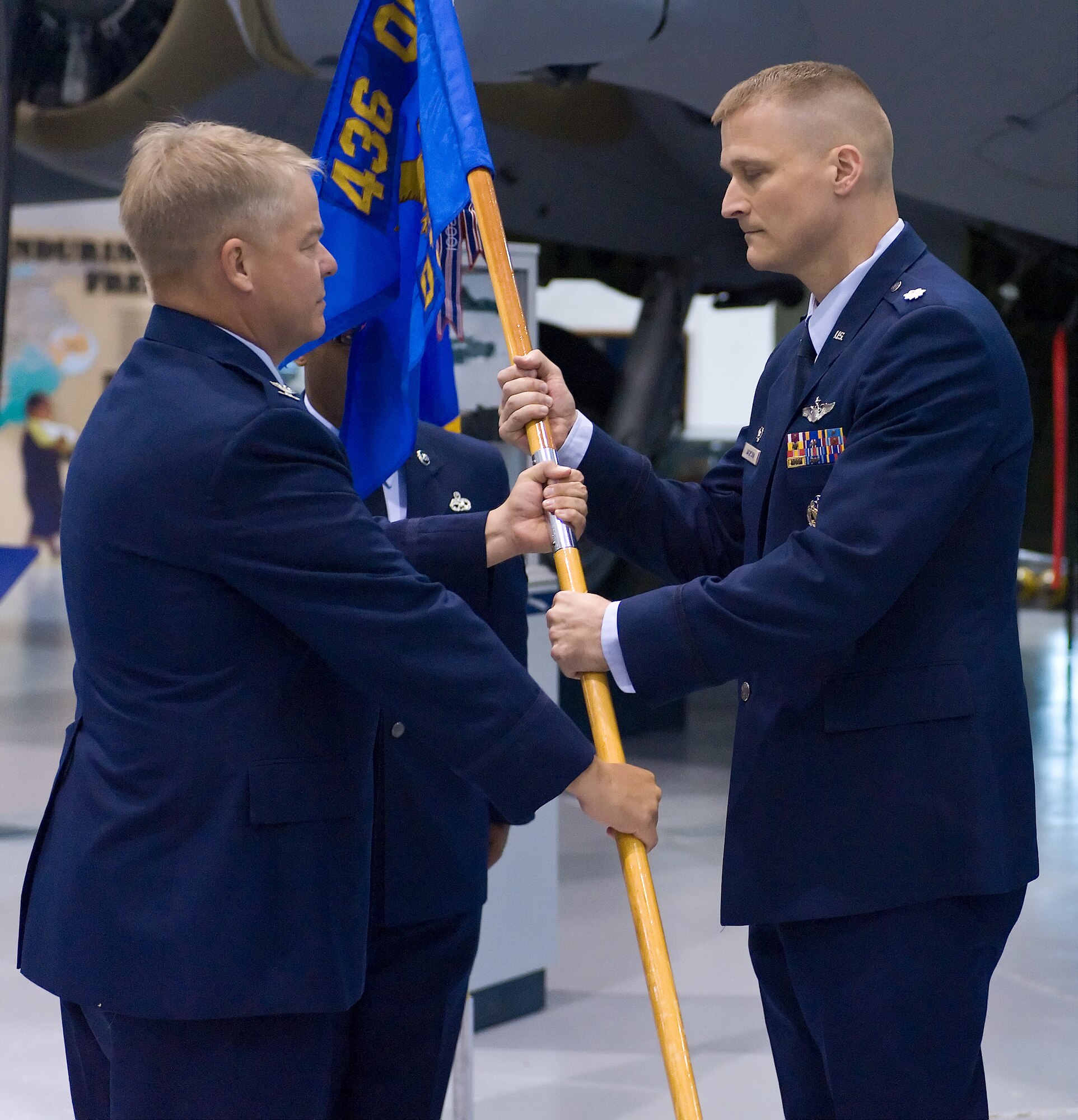 Col. David Hafer (left), 436th Operations Group commander, passes the guidon to Lt. Col. Douglas Jackson as he takes command of the 436th Operations Support Squadron July 11, 2011, at Dover Air Force Base, Del. (U.S. Air Force photo by Roland Balik)