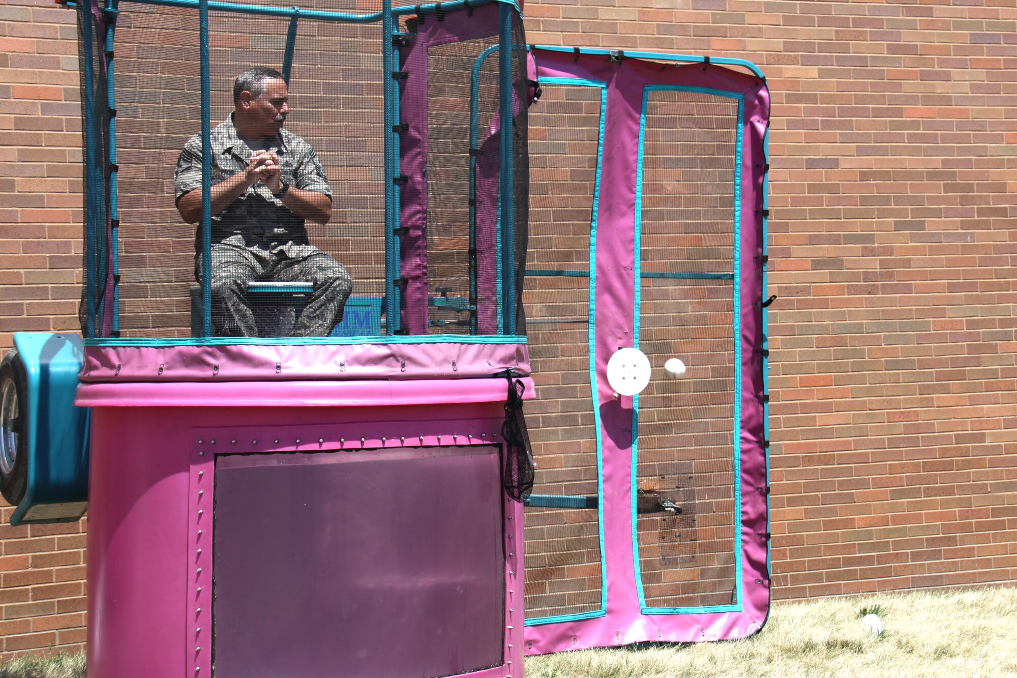 Chief Master Sgt. John Payne, Command Chief 911th Airlift Wing, prepares for a dip in the dunk tank as the ball makes it way on-target, during the 2011 Wing Family Day held here during the July Unit Training Assembly, July 10. The dunk tank was a big hit at the event providing the opportunity to dunk commanders, chiefs, and first sergeants stationed here.  (Photo by Senior Airman Melissa S Knox).