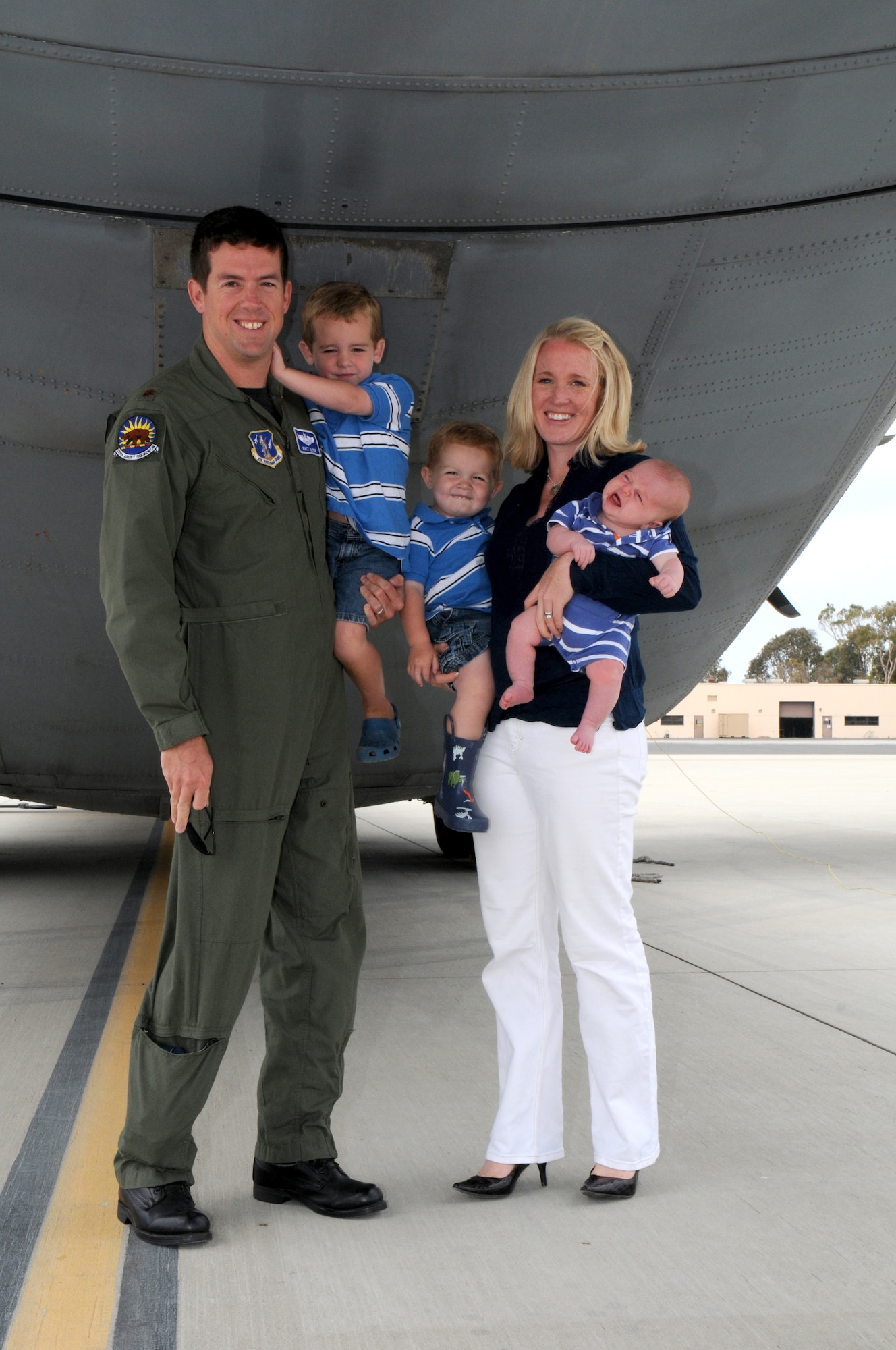 Megan Glynn and her husband, Maj. Matt Glynn, along with their three boys, Murphy, JP and Cooper, stand behind her husband's C-130J Super Hercules July 13, 2011.  Megan was named the 2011 Air Force Spouse of the Year in an award program sponsored by Military Spouse magazine.  The major is a C-130J pilot with the California Air National Guard’s 146 Airlift Wing at Channel Islands ANG Station near Oxnard, Calif.  (U.S. Air Force photo)