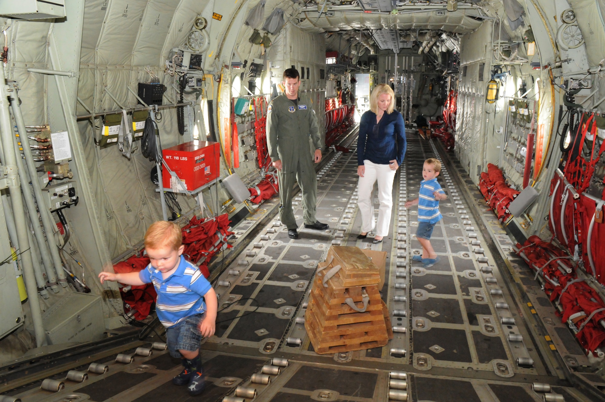 Megan Glynn, named the 2011 Air Force Spouse of the Year in an award program sponsored by Military Spouse magazine, and her husband, Maj. Matt Glynn, watch as two of their three boys, Murphy (foreground) and JP, explore the inside of a C-130J Super Hercules July 13, 2011.  Her husband is a C-130J pilot with the California Air National Guard’s 146 Airlift Wing at Channel Islands ANG Station near Oxnard, Calif.  (U.S. Air Force photo)