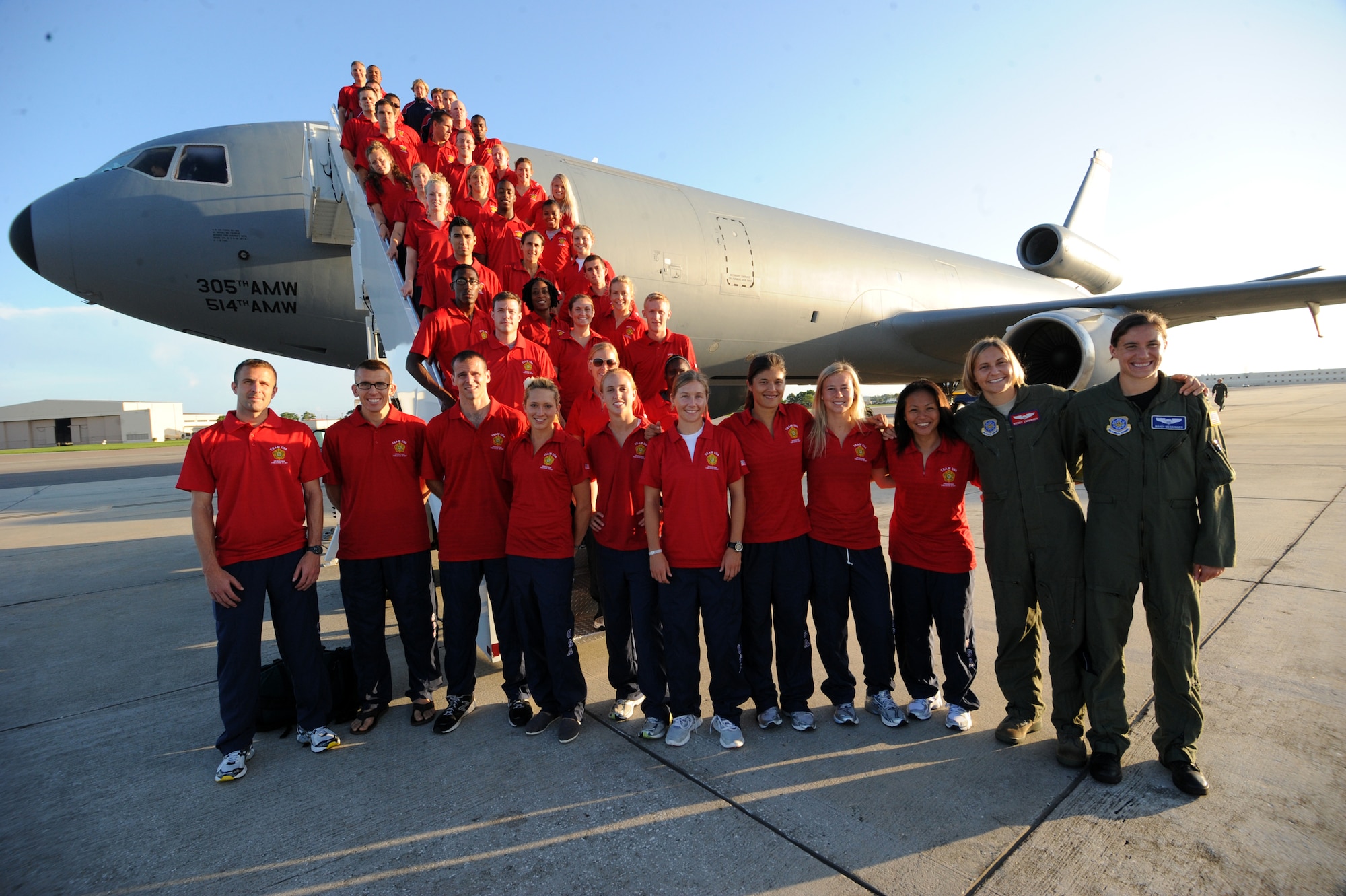Military Team USA women’s soccer and track and field athletes get set to jet from MacDill Air Force Base, Fla., to Galeao Air Base in Rio de Janeiro, Brazil, July 13 to compete in the Counseil International du Sport Militaire's 5th Military World Games. On the far right end of first row: Air Force Capt. Wendy Emminger and 1st Lt. Mandi Messinger, U.S. military soccer players who piloted the teams aboard a KC-10 Extender from MacDill to Rio. They were supported by a flight crew from the 305th Air Mobility Wing at Joint Base McGuire-Dix-Lakehurst, N.J. (U.S. Army photo by Tim Hipps/Released)