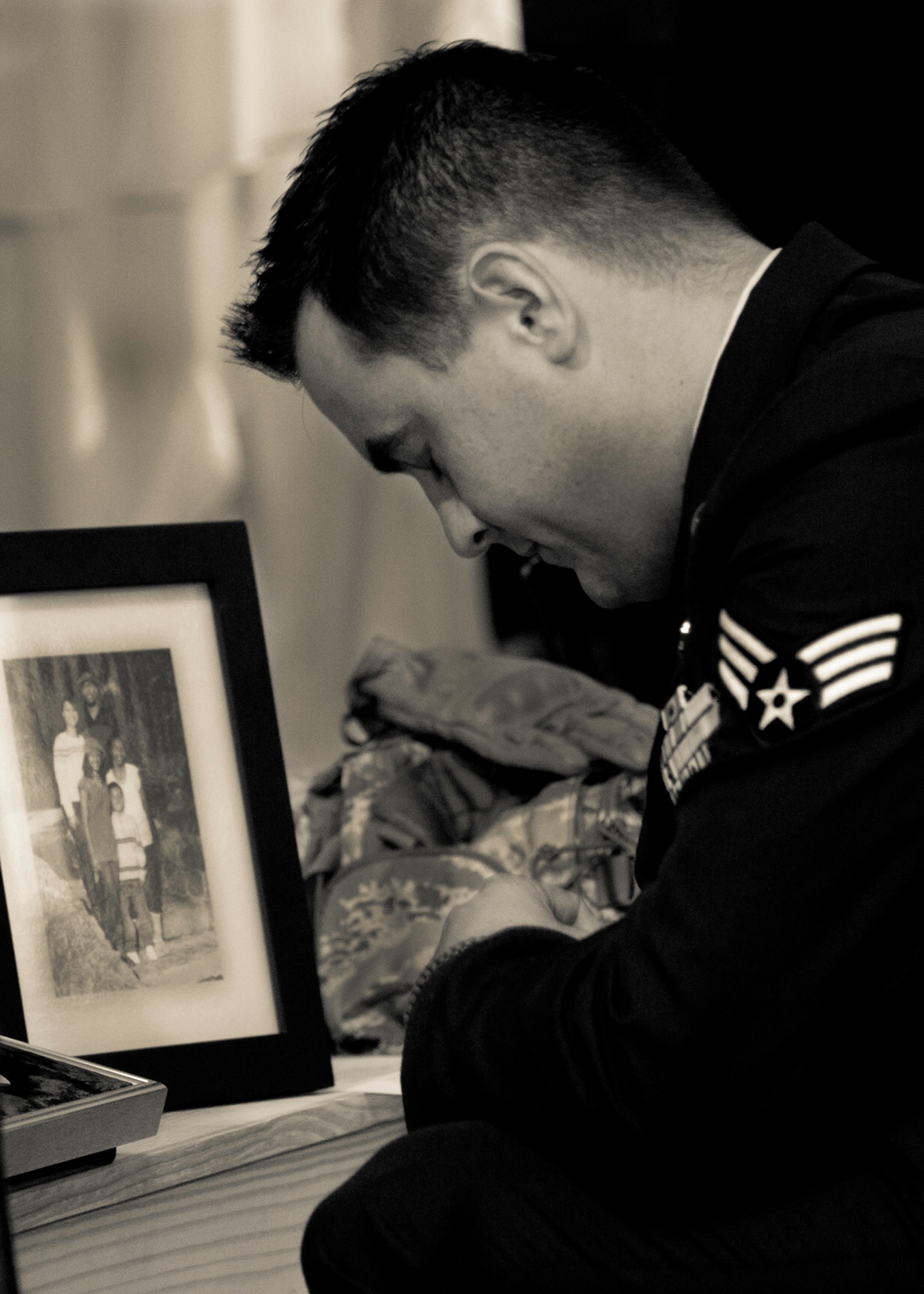 Senior Airman Kyle Massengale, of the 96th Civil Engineer Squadron, says goodbye to Tech. Sgt. Daniel Douville after a memorial ceremony for him at Eglin Air Force Base, July 14.  Douville, an EOD technician with the 96th CES, died June 26 as a result of injuries suffered from an improvised explosive device in Afghanistan.  Friends, family and the local community turned out to remember and praise his contributions to his country.  (U.S. Air Force photo/Samuel King Jr.)