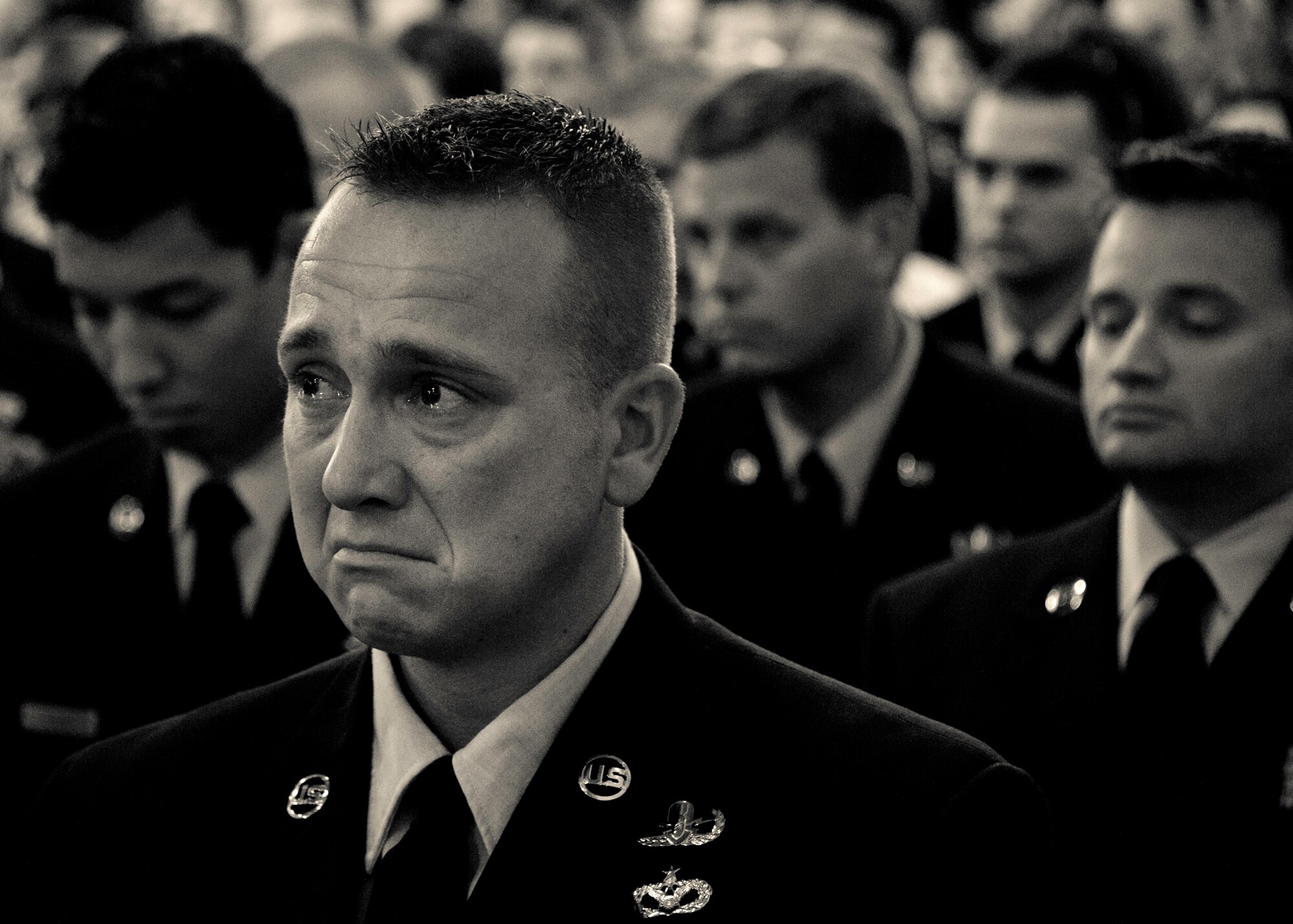 Staff Sgt. Adam Meredith, of the 96th Civil Engineer Squadron, fights back tears during a memorial ceremony honoring his friend and fellow Airman, Tech. Sgt. Daniel Douville at Eglin Air Force Base, July 14.  Douville, an explosive ordnance disposal technician with the 96th CES, died June 26 as a result of injuries suffered from an improvised explosive device in Afghanistan.  Friends, family and the local community turned out to remember and praise his contributions to his country.  (U.S. Air Force photo/Samuel King Jr.)
