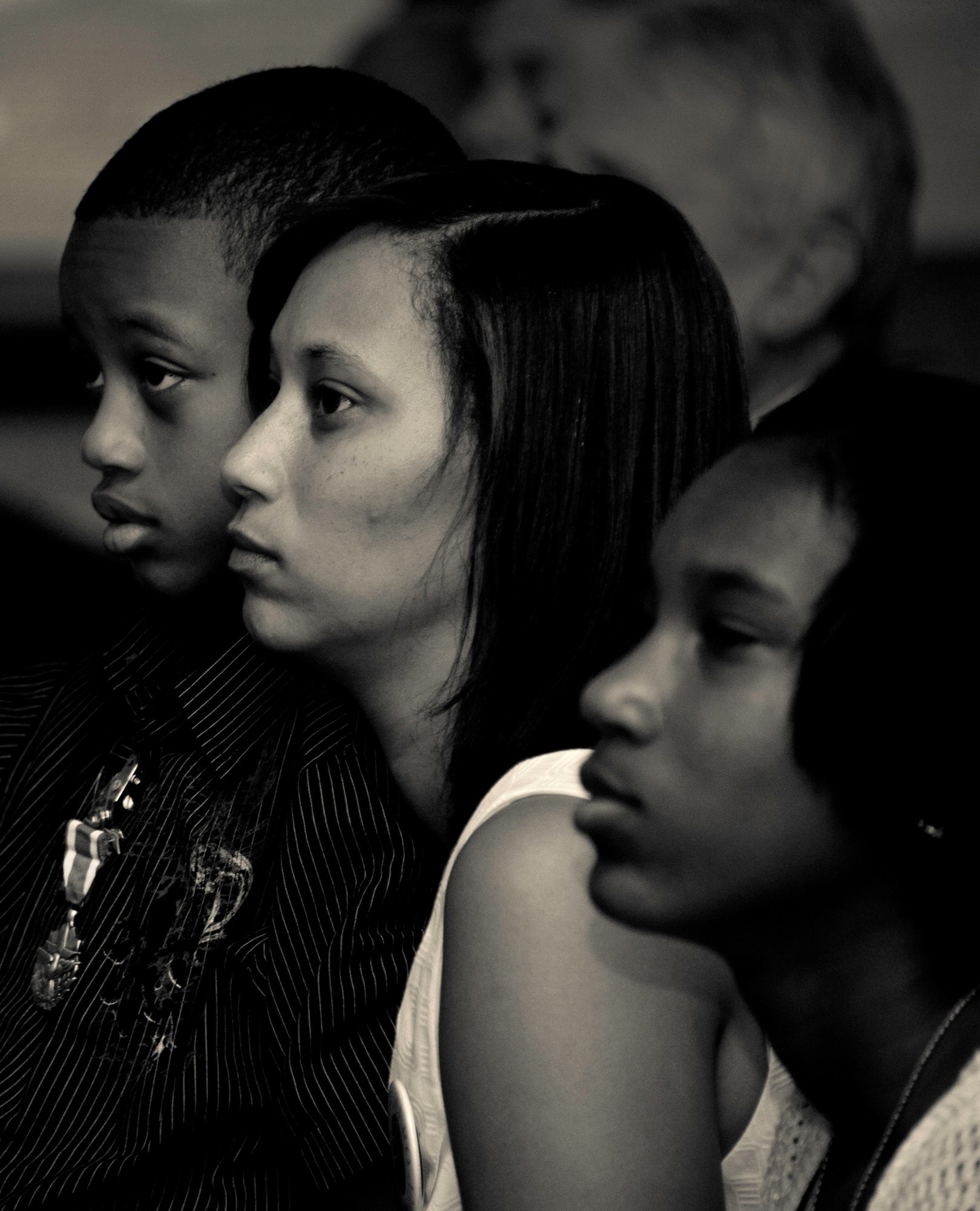 Tech. Sgt. Daniel Douville’s son Daniel Jr., widow LaShana, and daughter Jadelynn listen to the sermon during the memorial ceremony for Douville at Eglin Air Force Base, July 14.  Douville, an explosive ordnance disposal technician with the 96th Civil Engineer Squadron, died June 26 as a result of injuries suffered from an improvised explosive device in Afghanistan.  Friends, family and the local community turned out to remember and praise his contributions to his country.  (U.S. Air Force photo/Samuel King Jr.)
