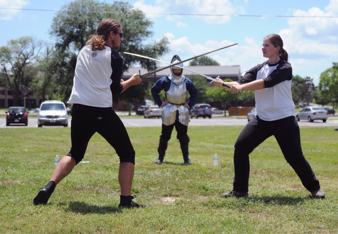 John Bax and Betsy Taylor of the Medieval European Martial Arts Guild spar in a demonstration at the Andrews Library's A Mid-summer Knight's Read summer reading program July 16.  The library's summer reading program will feture several Medeival-themed events for children of all ages. (U.S. Air Force Photo by Senior Airman Torey Griffith)