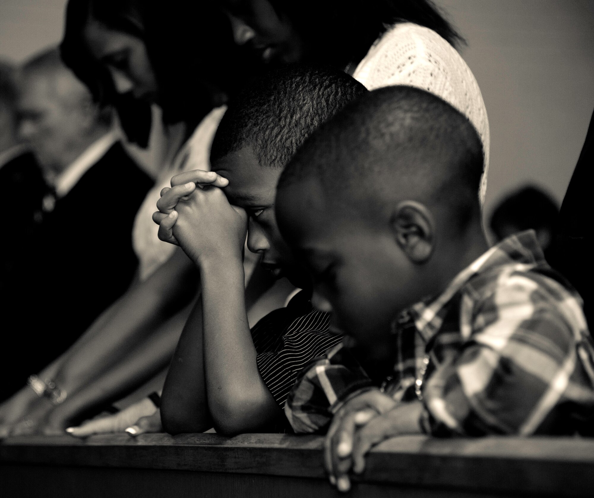 Daniel Jr., son of Tech. Sgt. Daniel Douville, of the 96th Civil Engineer Squadron, folds his hands in prayer during the invocation at a memorial ceremony honoring his father at Eglin Air Force Base, July 14.  Douville, an explosive ordnance disposal technician, died June 26, as a result of injuries suffered from an improvised explosive device in Afghanistan.  Friends, family and the local community turned out to remember and praise his contributions to his country.  (U.S. Air Force photo/Samuel King Jr.)