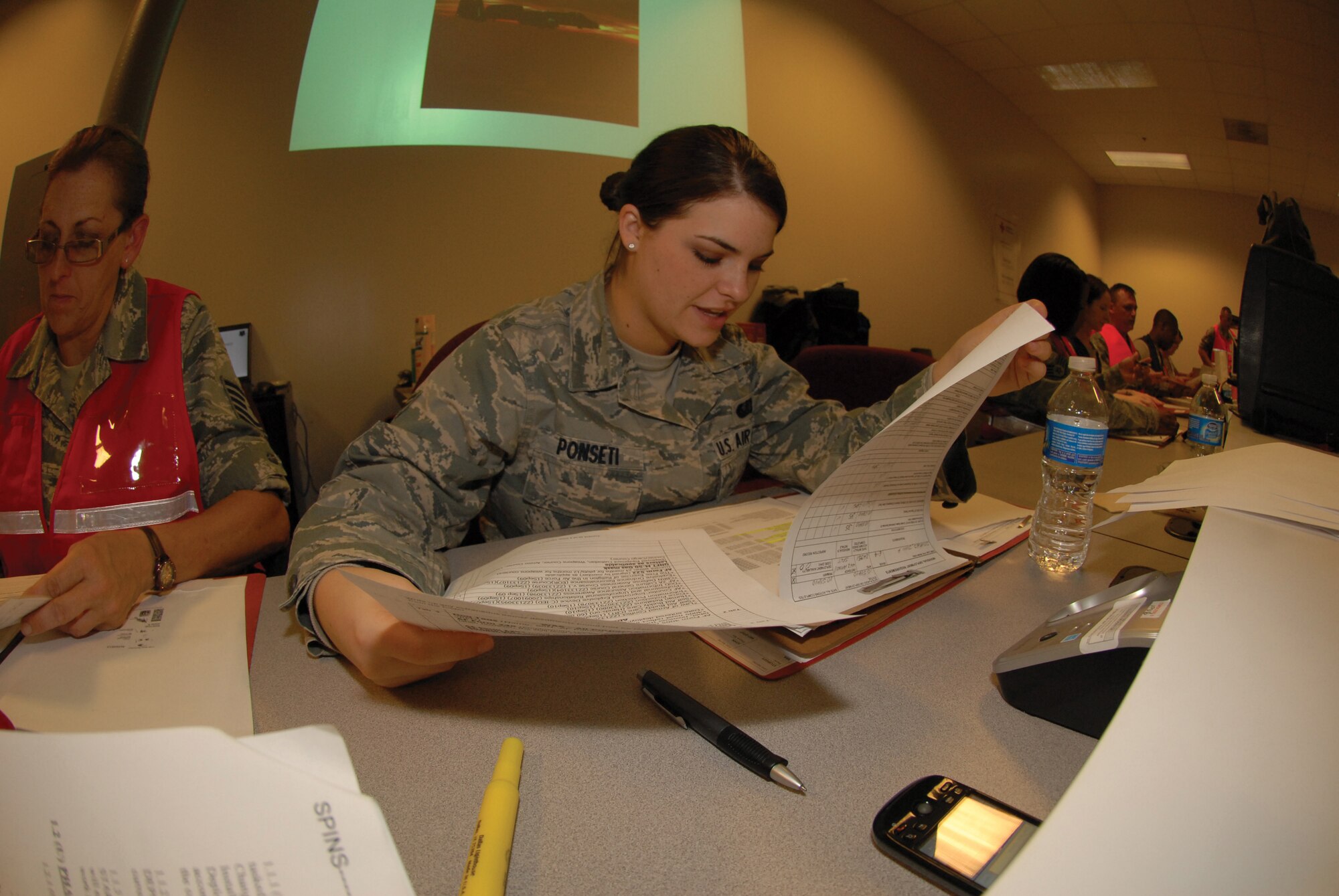 Senior Airman Angelle Ponseti, 442nd Force Support Squadron, reviews a deployment folder while working in the wing assembly area during a phase-one operational readiness exercise, June 4, 2011. The wing is scheduled to undergo an operational readiness inspection, August 2011. The 442nd FSS is part of the 442nd Fighter Wing, an A-10 Thunderbolt II Air Force Reserve unit, Whiteman Air Force Base, Mo. (U.S. Air Force photo/ Staff Sgt. Danielle Wolf)