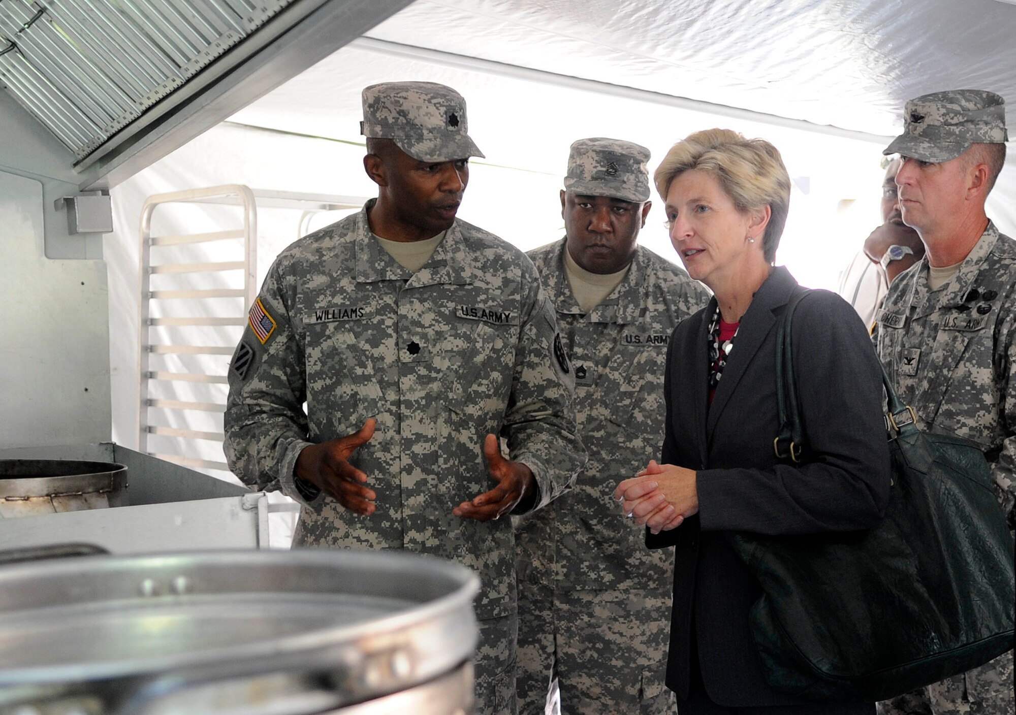 U.S. Army Lt. Col. Kenneth Williams, 10th Transportation Battalion commander, gives Dr. Jo Ann Rooney, Principal Under Secretary of Defense for Personnel and Readiness, a tour of the field kitchen during a visit to Fort Eustis, Va., July 13, 2011. Dr. Rooney visited with Soldiers of multiple units during her visit in order to better understand the overall mission and impact of Joint Base Langley-Eustis. (U.S. Air Force photo by Staff Sgt. Dana Hill/Released)