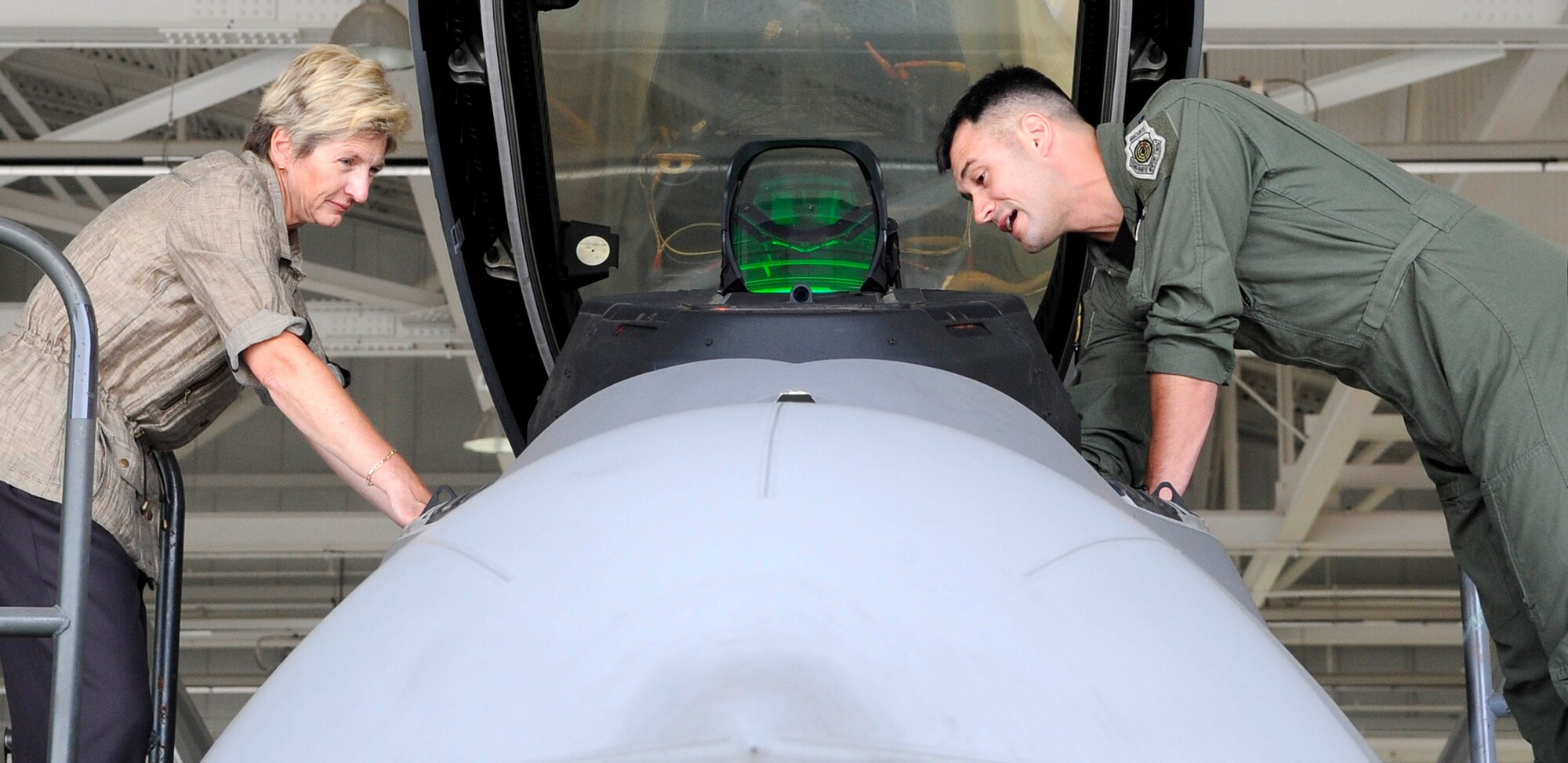Dr. Jo Ann Rooney, Principal Under Secretary of Defense for Personnel and Readiness, receives a mission brief and tour of the F-22 Raptor from Lt. Col. Peter Fesler, 27th Fighter Squadron commander, during a visit to Langley Air Force Base, Va., July 12, 2011. Dr. Rooney visited multiple units during her visit in order to better understand the overall mission and impact of Joint Base Langley-Eustis. (U.S. Air Force photo by Staff Sgt. Dana Hill/Released)