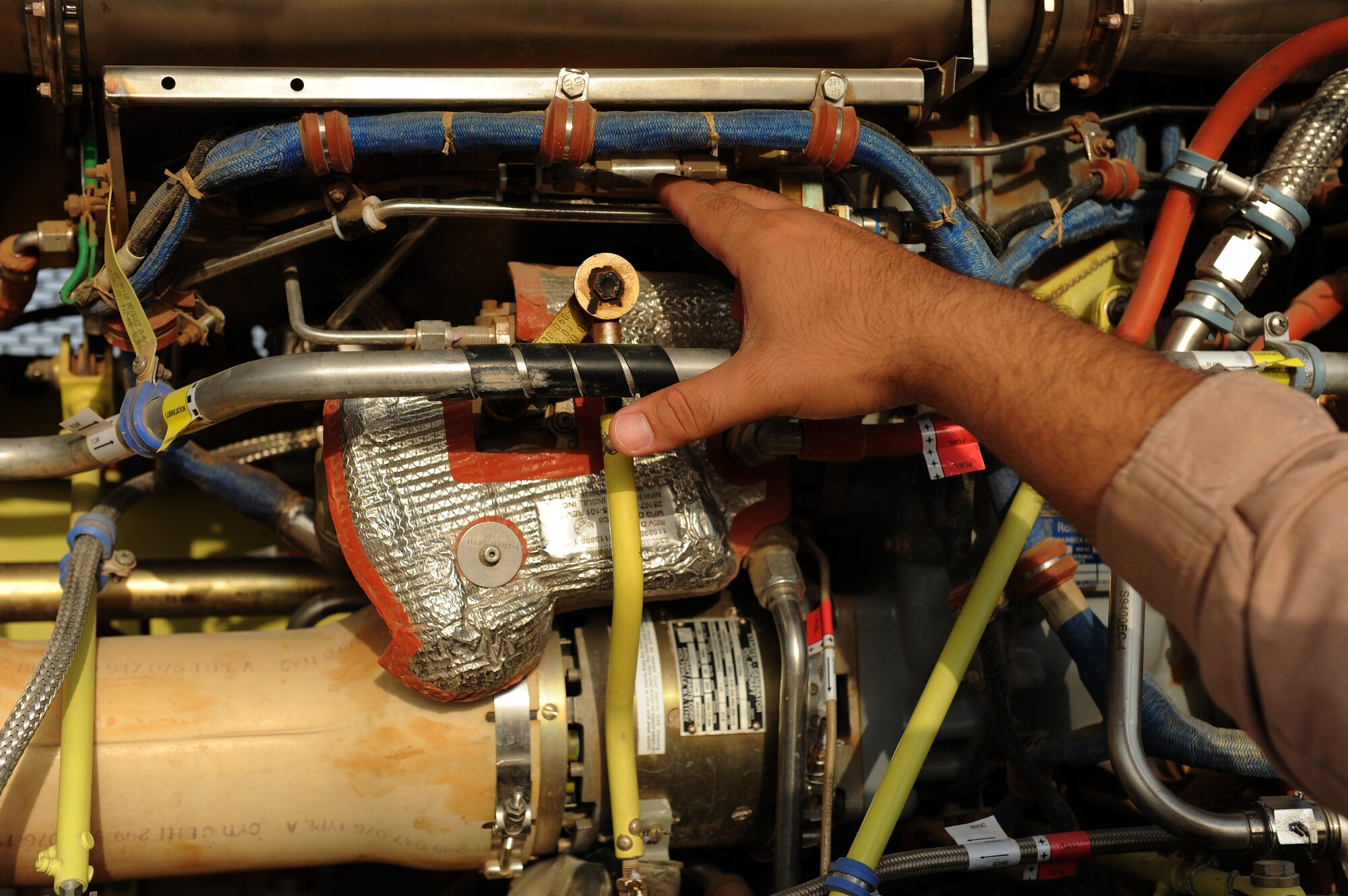 An Iraqi Army Aviation Command, Squadron 21 maintenance team member conducts an inspection of a Bell 407 helicopter at Taji Air Base, Iraq, July 14, 2011. Assigned to Taji Air Base, the 721st Air Expeditionary Advisory Squadron trains, advises and assists Iraqi pilots and maintenance personnel, focusing on sustainability, reliability and interoperability. (U.S. Air Force photo/Staff Sgt. Mike Meares)







