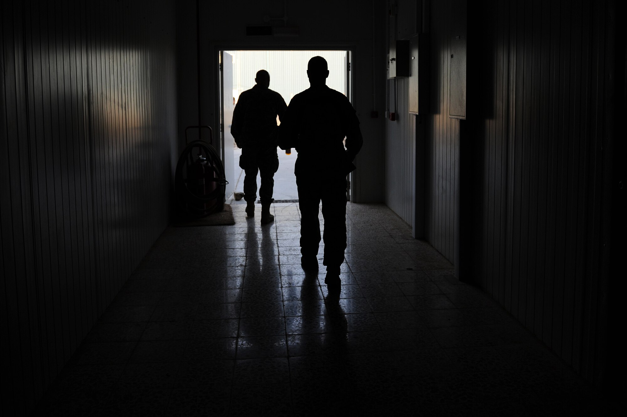 U.S. Army Maj. Kevin Ferner (right), 721st Air Expeditionary Advisory Squadron, and Bell 407 helicopter instructor pilot and an Iraqi Army Aviation Command, Squadron 21 pilot "step" to their Bell-407 helicopter for a training flight, Taji Air Base, Iraq, July 14, 2011. The 721st AEAS trains, advises and assists Iraqi pilots and maintenance personnel, focusing on sustainability, reliability and interoperability. (U.S. Air Force photo/Staff Sgt. Mike Meares)

