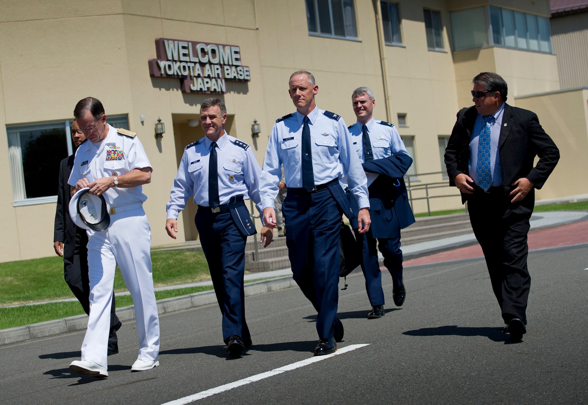 (From the left) U.S. Navy Adm. Mike Mullen, Chairman of the Joint Chiefs of Staff, walks with U.S. Air Force Lt. Gen. Burton Field, U.S. Forces Japan and 5th Air Force commander, and U.S. Air Force Col. Otto Feather, 374th Airlift Wing commander, at Yokota Air Base, Japan, July 15, 2011. (U.S. Air Force photo/Staff Sgt. Samuel Morse)