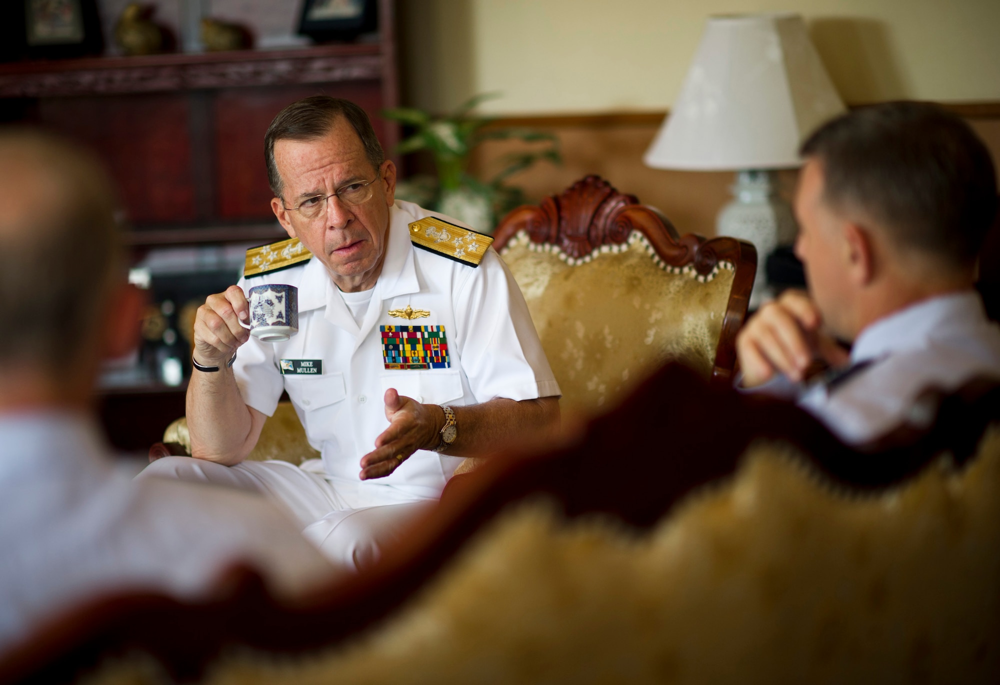 U.S. Navy Adm. Mike Mullen (center), Chairman of the Joint Chiefs of Staff, talks with U.S. Air Force Lt. Gen. Burton Field (right), U.S. Forces Japan and 5th Air Force commander, and U.S. Air Force Col. Otto Feather, 374th Airlift Wing commander, at the distinguished visitor lounge at Yokota Air Base, Japan, July 15, 2011. (U.S. Air Force photo/Staff Sgt. Samuel Morse)