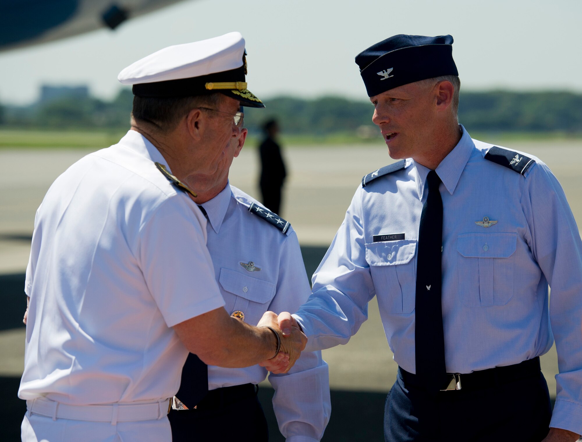 U.S. Navy Adm. Mike Mullen, Chairman of the Joint Chiefs of Staff, shakes hands with U.S. Air Force Col. Otto Feather, 374th Airlift Wing Commander, during a stop at Yokota Air Base, Japan, July 15, 2011. (U.S. Air Force photo/Staff Sgt. Samuel Morse)