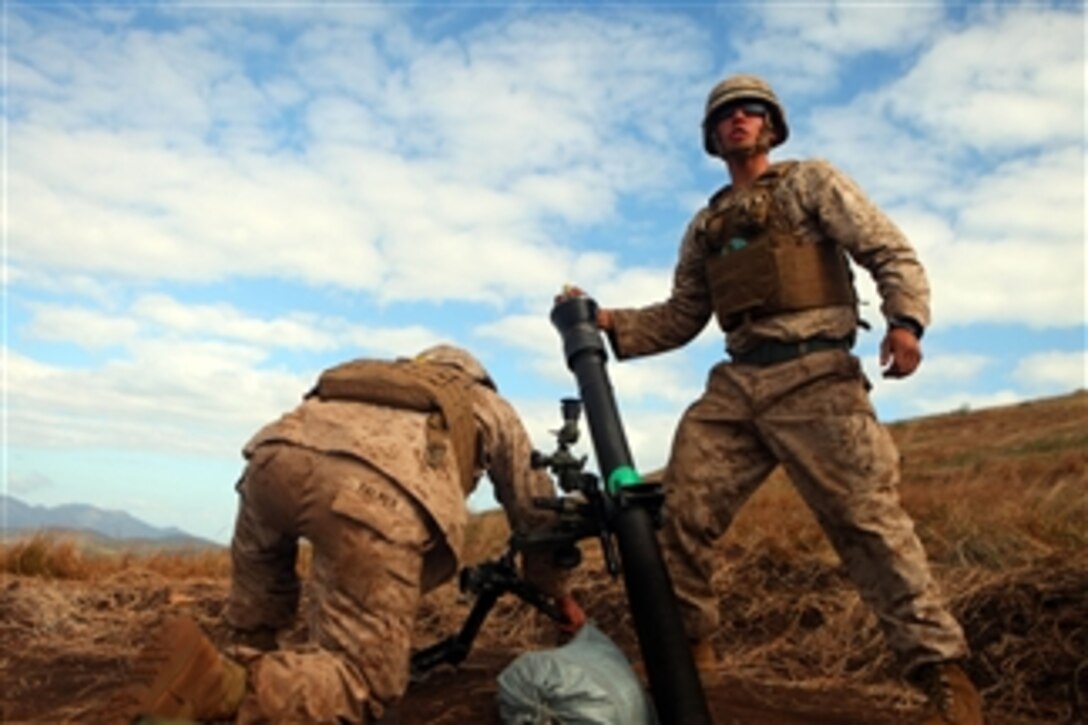 Lance Cpl. Kyle J. Palmer (right) and Lance Cpl. Samuel E. Robertson (left), mortarmen with the 81mm Mortars Platoon, Weapons Company, Battalion Landing Team 2nd Battalion, 7th Marines, 31st Marine Expeditionary Unit, prepare to fire a mortar during a joint live fire exercise on July 14, 2011.  Marines and sailors of the 31st Marine Expeditionary Unit are in Australia participating in exercise Talisman Sabre 2011.  Talisman Sabre is the largest joint military exercise undertaken by the Australian Defense Force.  