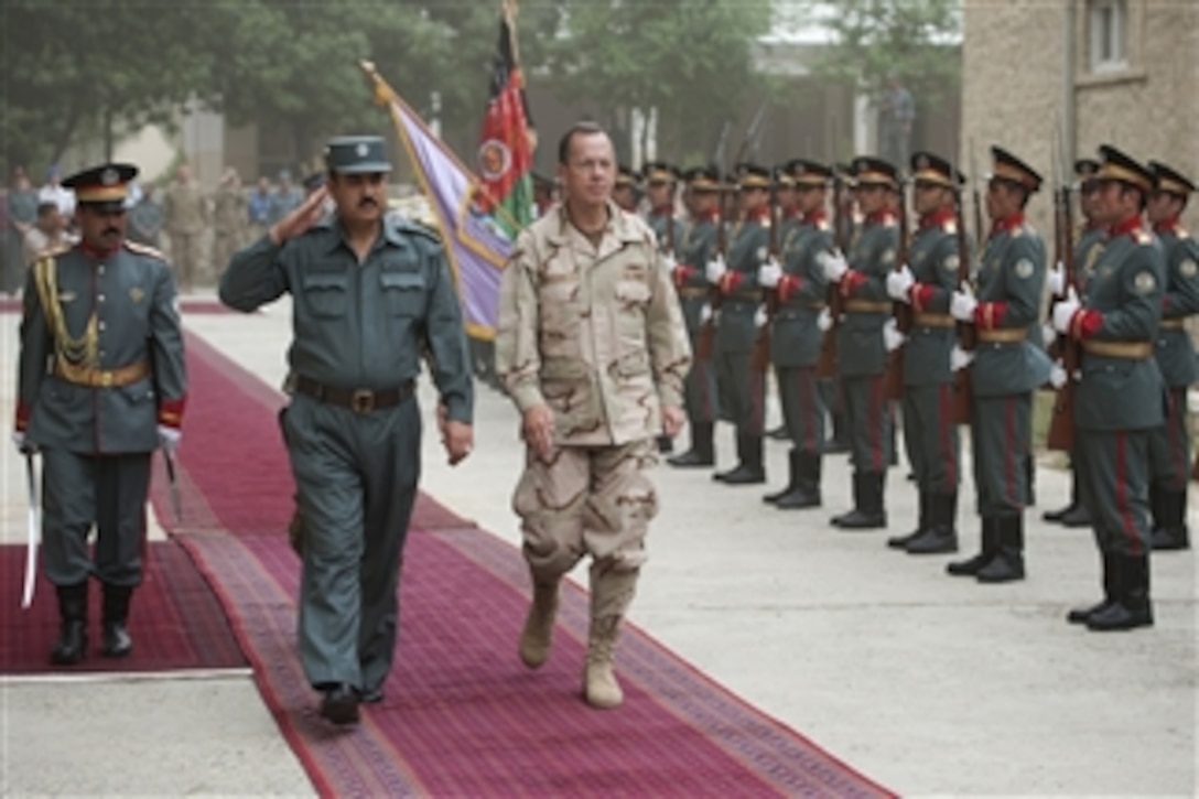 Chairman of the Joint Chiefs of Staff Adm. Mike Mullen reviews Afghan National Policemen with Regional Commander North, Afghan National Police Gen. Ghulam Mujtaba Patang in Mazar-e-Sharif, Afghanistan, on July 17, 2011.  