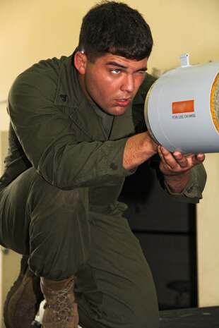 Cpl. John A. Moore, a Marine Aviation Logistics Squadron 12 aviation ordnance technician, aligns a part of the Guided Bomb Unit-12 he is working on before torqueing it down to the unit in a warehouse on the flightline here in support of exercise Talisman Sabre 2011 July 19. The MALS-12 service members are slated to provide thousands of pounds of live ordnance during the course of the exercise.
