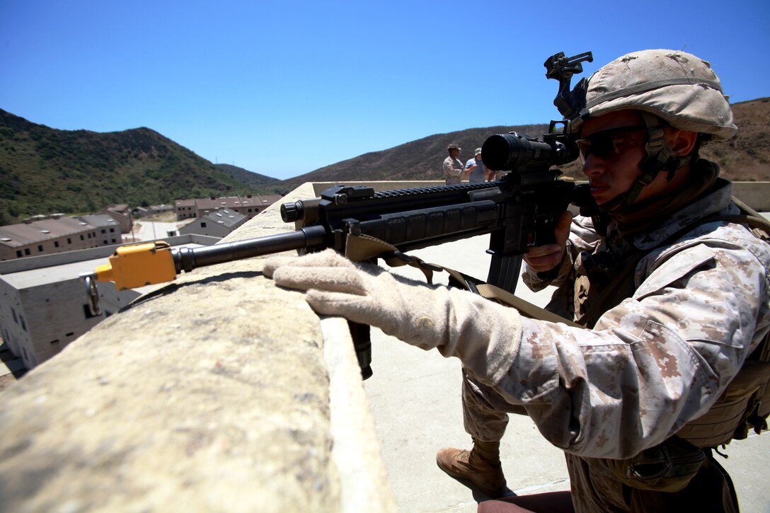 A Marine with Battalion Landing Team 3/1, 11th Marine Expeditionary Unit, provides security during a counterinsurgency exercise here July 18. The Marines and sailors with the unit are preparing for their upcoming Western Pacific deployment.
