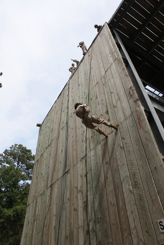 A midshipman going through the Career Orientation and Training for Midshipmen program rappels down the tower during the weeklong training aboard the base. The visit was a chance for midshipmen to see what the Marine Corps has to offer as well as understand how the Marine Corps works and the daily lives of Marines.