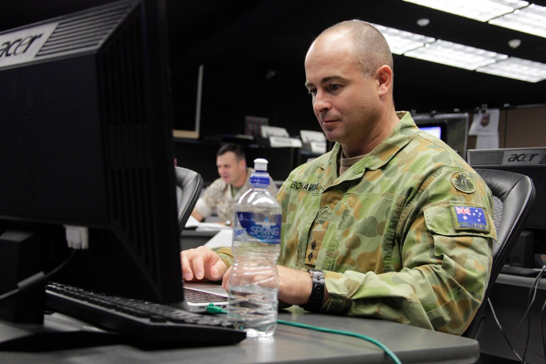 Australian Army Lt. Col. Simon Bonavita, the Australian Army liaison for the Marine Corps, checks the activity on screen from the Allied Auroras exercise at the Simulation Center July 19, 2011.