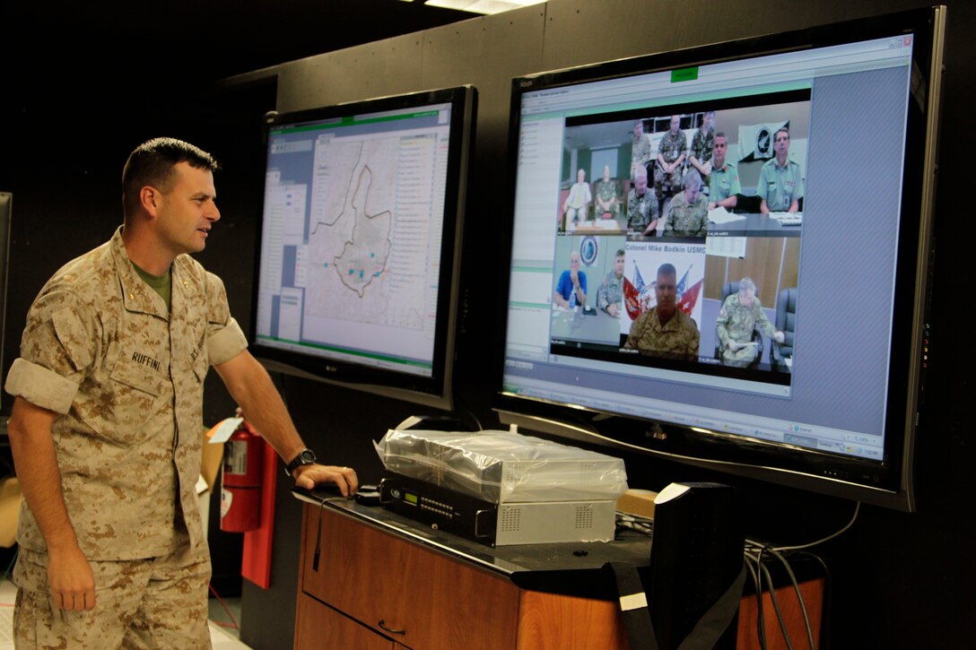 Major John Ruffini, a future plans officer, looks at a teleconference between multiple leaders from the U.S., Britain, Australia, Canada and New Zealand during the Allied Auroras exercise July 19, 2011, at the Combat Center’s Simulation Center.