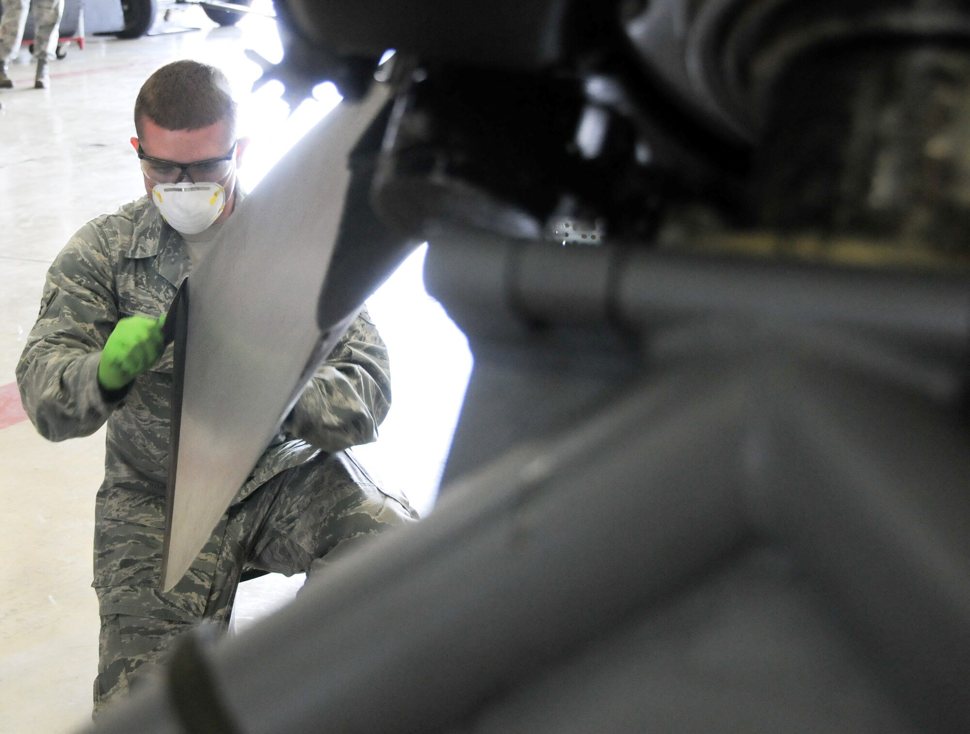 YOKOTA AIR BASE, Japan -- Airman Brendan Johnson, 374th Maintenance Squadron Propulsion Flight aerospace propulsion apprentice, sands the leading edge of a C-130 Hercules propeller at Yokota Air Base, Japan, July 14, 2011. Sanding the blades keeps them smooth and reduces the chance of cracks forming. (U.S. Air Force photo/Airman 1st Class Krystal M. Garrett)