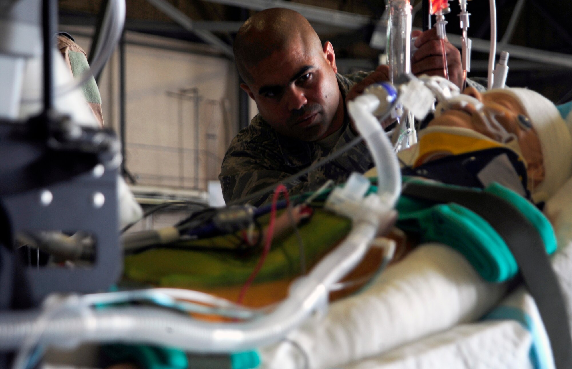 JOINT BASE LEWIS-MCCHORD, Wash. - Capt. Orlando Duran sets up a display of critical care air transport team equipment June 19, 2011. Duran is a presenter at the International Aeromedical Evacuation/En Route Care Conference, held here July 20-21, 2011. The conference is the first, U.S.-led international symposium on in-flight medical care. The event features speakers from a variety of countries sharing their stories, advice and lessons learned with hundreds of fellow doctors, nurses, paramedics and medical specialists. Officials expect representatives from 28 nations to attend the event. Duran is a registered nurse stationed at Lackland Air Force Base, Texas. (U.S. Air Force photo/Staff Sgt. J.G. Buzanowski)