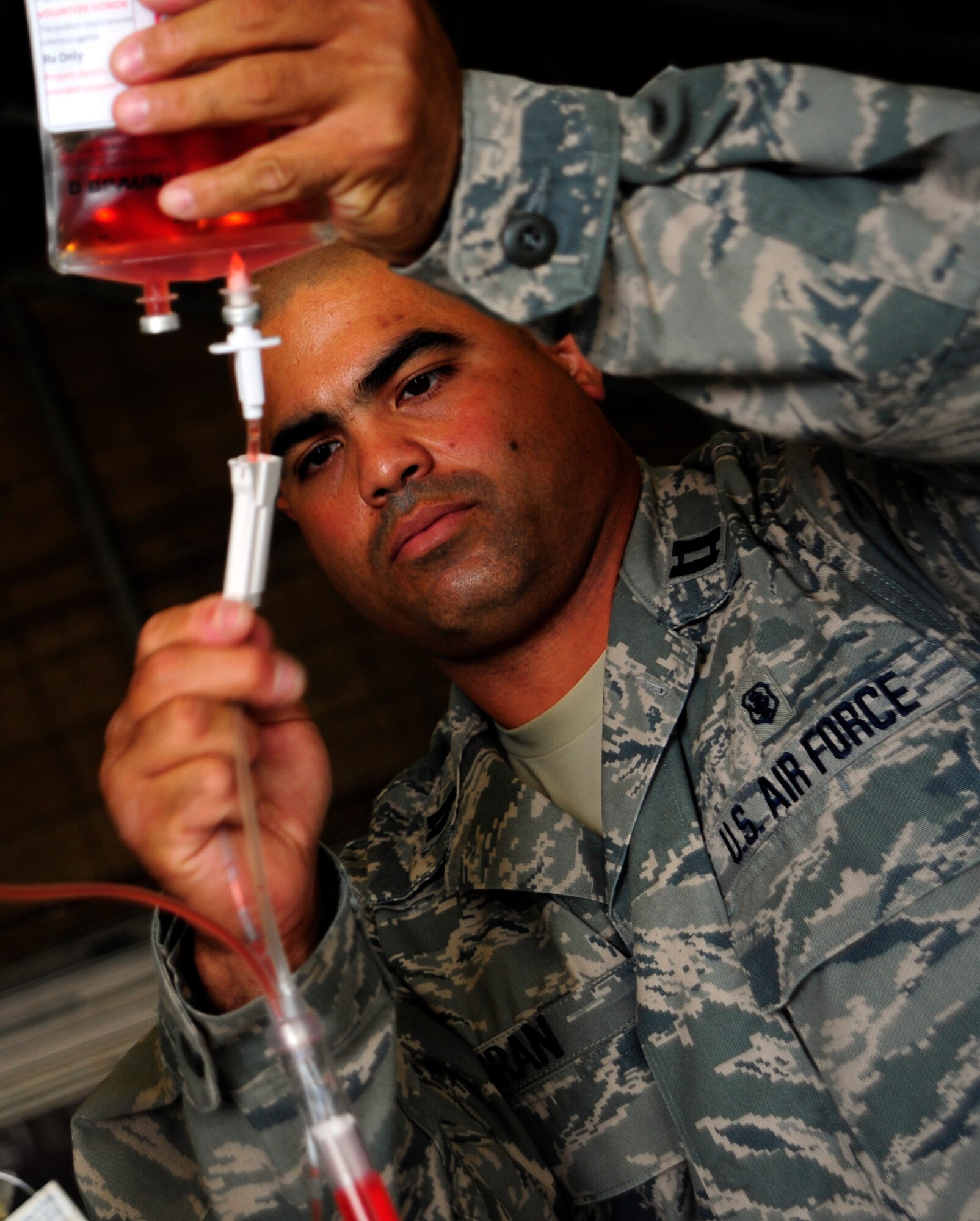 JOINT BASE LEWIS-MCCHORD, Wash. - Capt. Orlando Duran sets up a display of critical care air transport team equipment June 19, 2011. Duran is a presenter at the International Aeromedical Evacuation/En Route Care Conference, held here July 20-21, 2011. The conference is the first, U.S.-led international symposium on in-flight medical care. The event features speakers from a variety of countries sharing their stories, advice and lessons learned with hundreds of fellow doctors, nurses, paramedics and medical specialists. Officials expect representatives from 28 nations to attend the event. Duran is a registered nurse stationed at Lackland Air Force Base, Texas. (U.S. Air Force photo/Staff Sgt. J.G. Buzanowski)