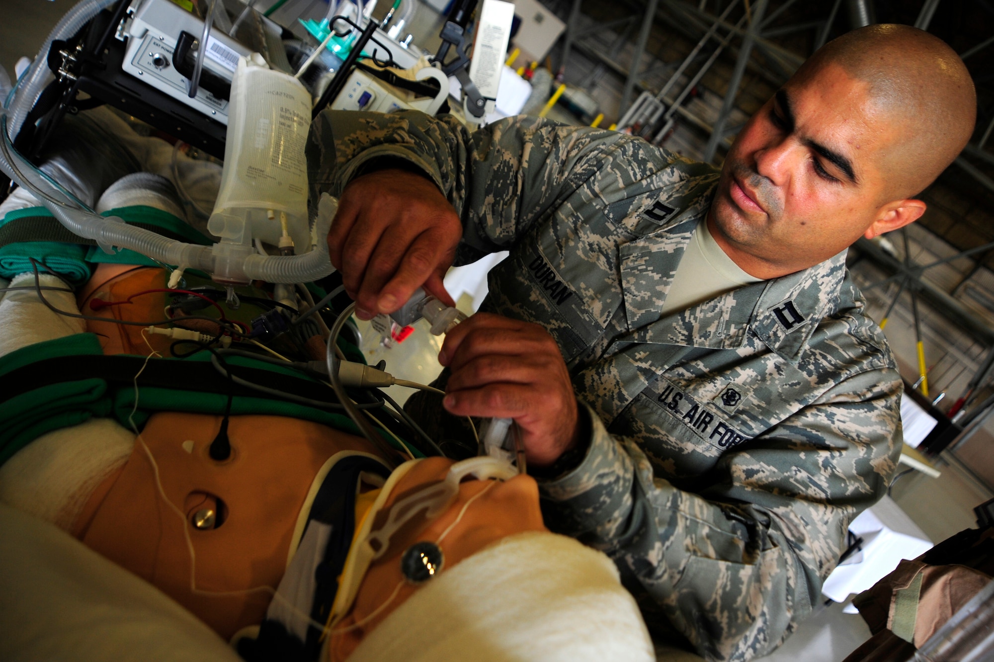 JOINT BASE LEWIS-MCCHORD, Wash. - Capt. Orlando Duran sets up a display of critical care air transport team equipment June 19, 2011. Duran is a presenter at the International Aeromedical Evacuation/En Route Care Conference, held here July 20-21, 2011. The conference is the first, U.S.-led international symposium on in-flight medical care. The event features speakers from a variety of countries sharing their stories, advice and lessons learned with hundreds of fellow doctors, nurses, paramedics and medical specialists. Officials expect representatives from 28 nations to attend the event. Duran is a registered nurse stationed at Lackland Air Force Base, Texas. (U.S. Air Force photo/Staff Sgt. J.G. Buzanowski)