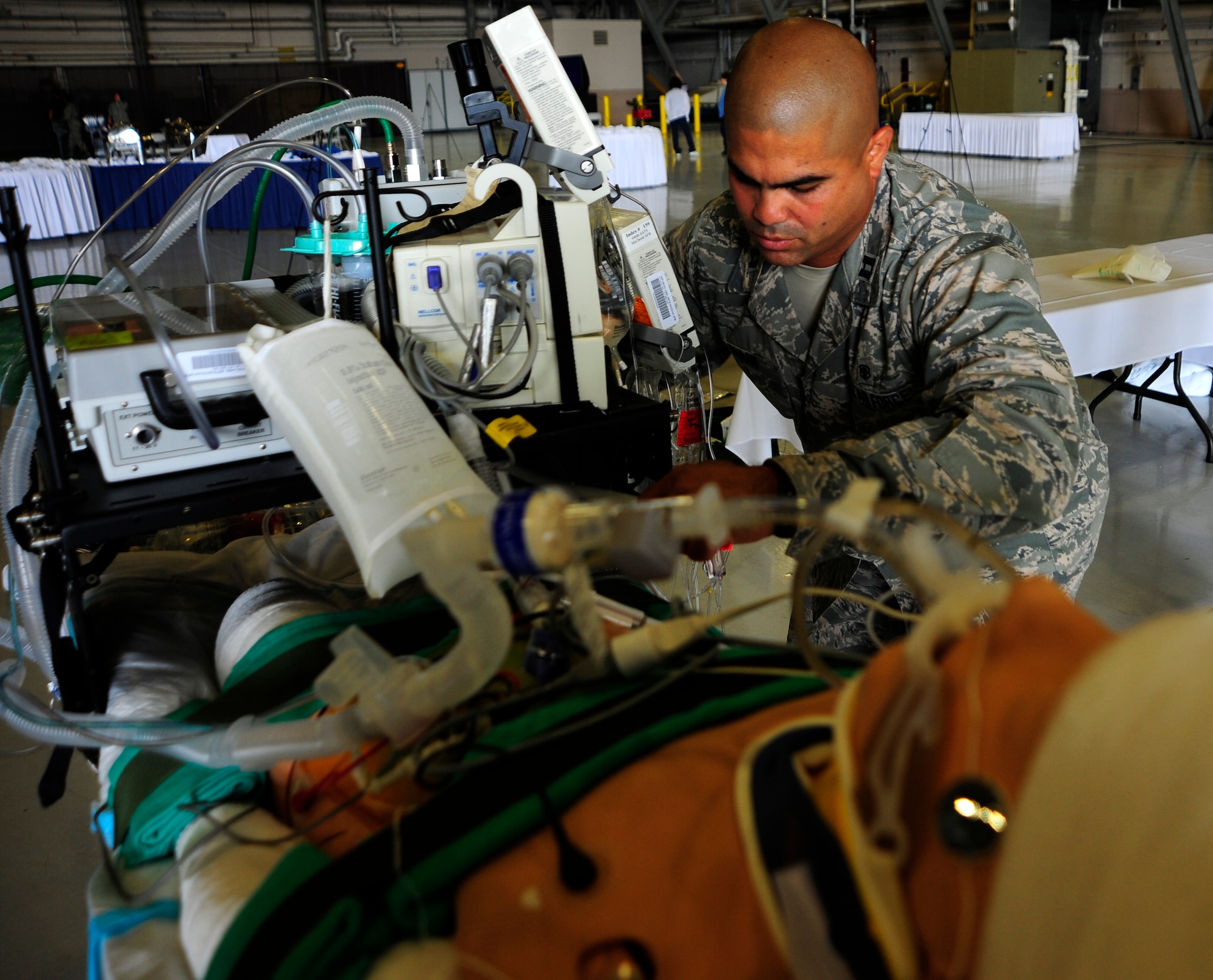 JOINT BASE LEWIS-MCCHORD, Wash. - Capt. Orlando Duran sets up a display of critical care air transport team equipment June 19, 2011. Duran is a presenter at the International Aeromedical Evacuation/En Route Care Conference, held here July 20-21, 2011. The conference is the first, U.S.-led international symposium on in-flight medical care. The event features speakers from a variety of countries sharing their stories, advice and lessons learned with hundreds of fellow doctors, nurses, paramedics and medical specialists. Officials expect representatives from 28 nations to attend the event. Duran is a registered nurse stationed at Lackland Air Force Base, Texas. (U.S. Air Force photo/Staff Sgt. J.G. Buzanowski)