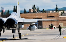 A member of the Japan Air Self Defense Force maintenance squadron guides a F-15 Eagle fighter jet July 15, 2011, Eielson Air Force Base, Alaska.  Several Japan Air Self-Defense Force Mitsubishi F-15 Eagles joined other RED FLAG-Alaska participants July 12 after having its entire F-15 fighter fleet grounded in response to an incident on July 4 with one of the fighter jets during a routine training exercise back in Japan.   The F-15 Eagle belongs to the Japan Air Self Defense Force.   (U.S. Air Force photo by/Staff Sgt. Miguel Lara)