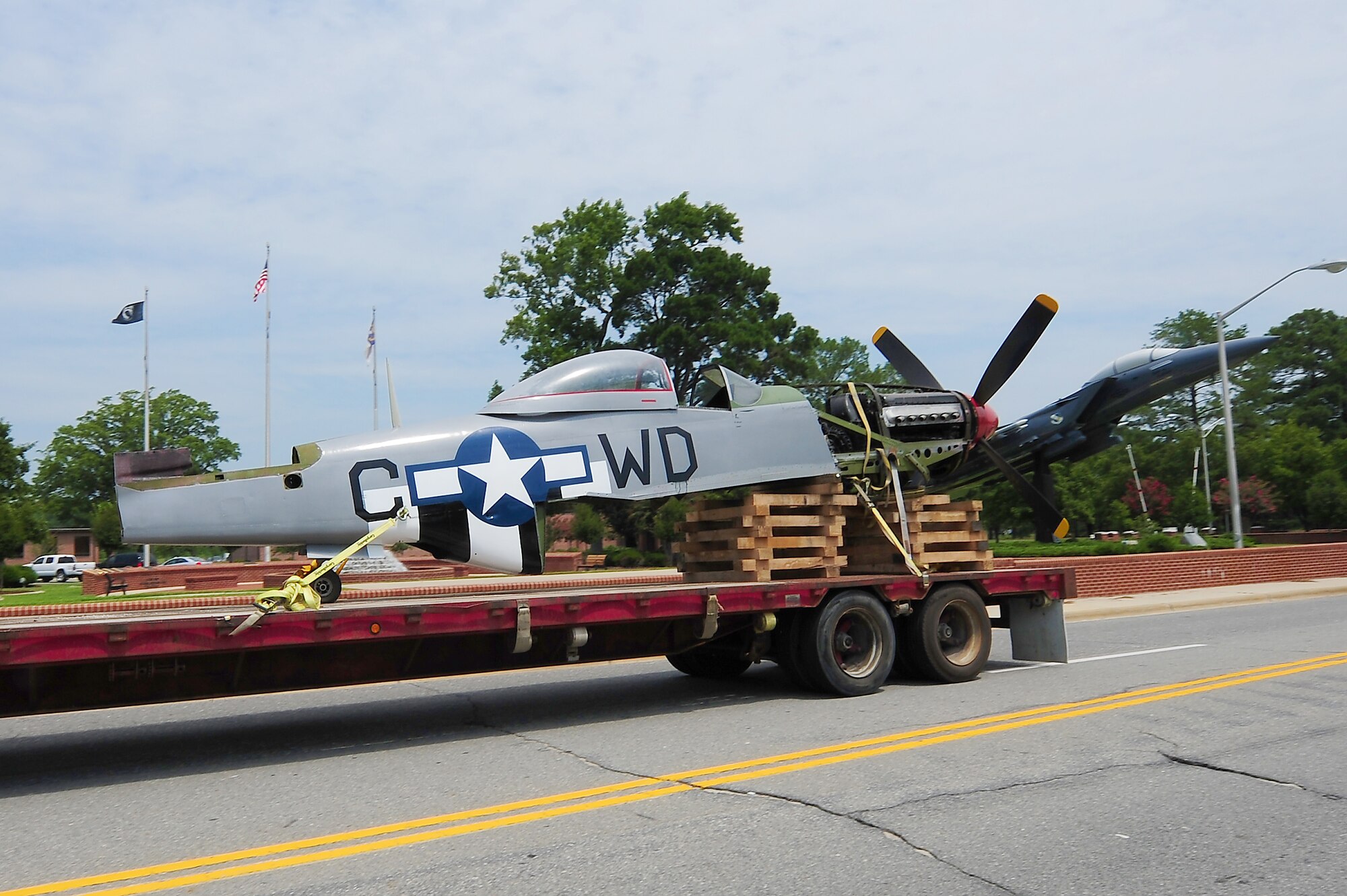 SEYMOUR JOHNSON AIR FORCE BASE, N.C. – A P-51D Mustang painted to resemble Col. Don Blakeslee’s plane from World War II is pulled past Heritage Park on a journey to its new home, the newly constructed 4th Mission Support Group consolidated support center here July 13, 2011. Blakeslee was the commander of the 4th Fighter Group from January to November of 1944, and transitioned the 4th FG from the P-47 Thunderbolts to the P-51 Mustangs in only 24 hours. (U.S. Air Force photo by Senior Airman Rae Perry/RELEASED)