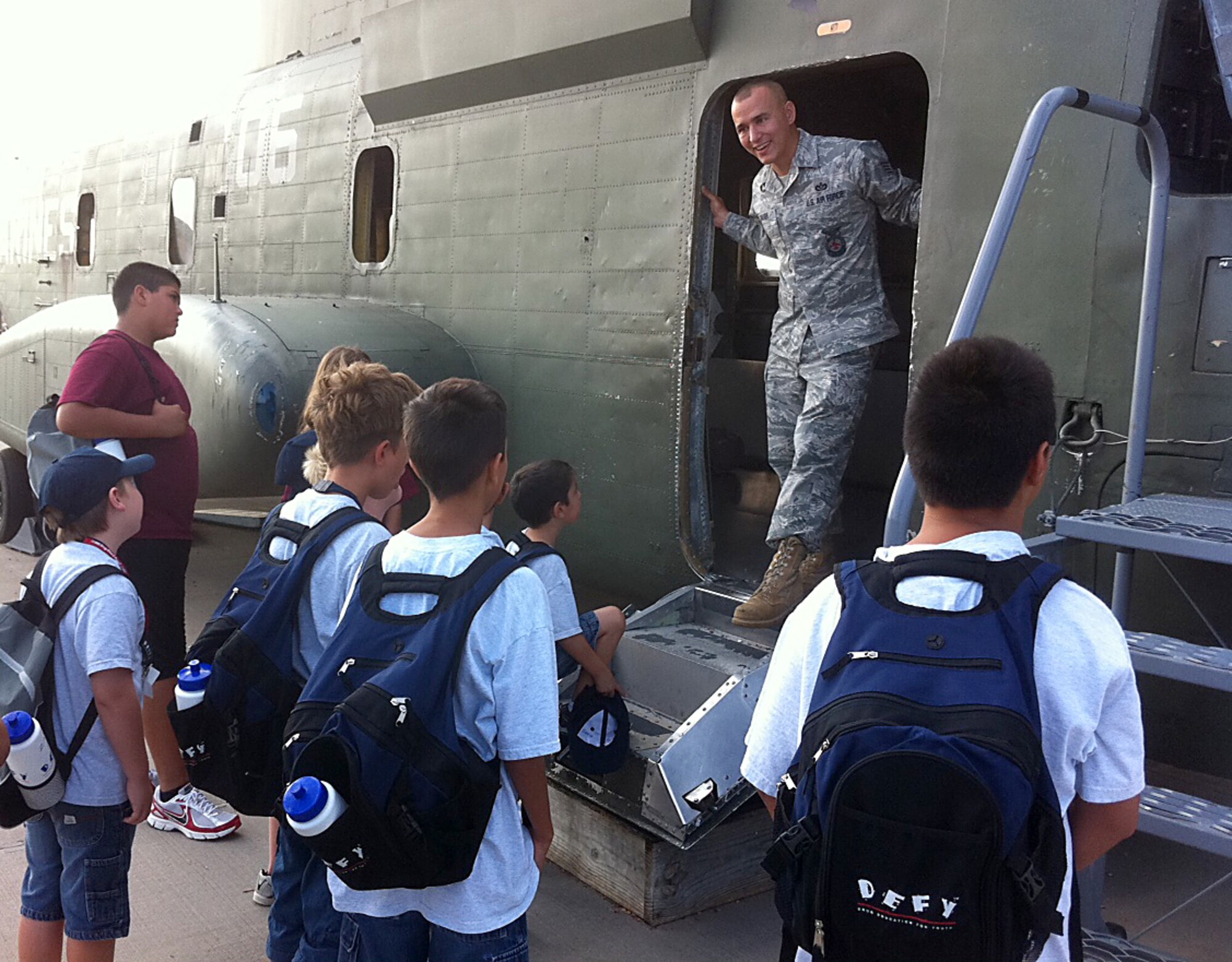 GOODFELLOW AIR FORCE BASE, Texas -- Staff Sgt. Jason Baugh, 312th Training Squadron Instructor, talks to DEFY Camp youths about combating aircraft fires during the group's tour at the Louis F. Garland Fire Academy here July 19.  (Courtesy photo/Navy Petty Officer 2nd Class Dennis Delarama)