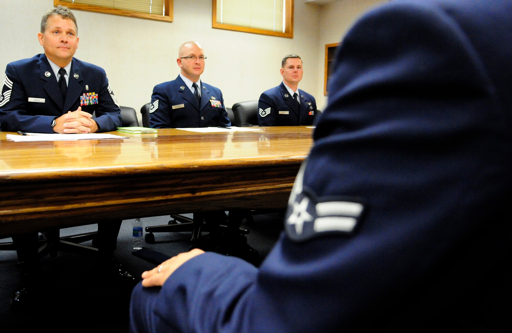A board meets with a quarterly award nominee July 15, 2011, Eielson Air Force Base, Alaska. The board now allows Airmen the opportunity to show off their knowledge of National and Air Force current events, basic Air Force information such as customs and courtesies, and their role in the 354th FW mission in a face-to-face session. (U.S. Air Force photo by/Senior Airman Rachelle Coleman)