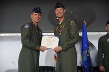 U.S. Air Force Maj. Gen. Stephen Hoog, 9th Air Force commander, presents the Legion of Merit award to Col. Gary Henderson, outgoing 23rd Wing commander, at Moody Air Force Base Ga., July 19, 2011. Henderson earned the award for his leadership of the wing. (U.S. Air Force photo by Airman 1st Class Paul Francis/Released)