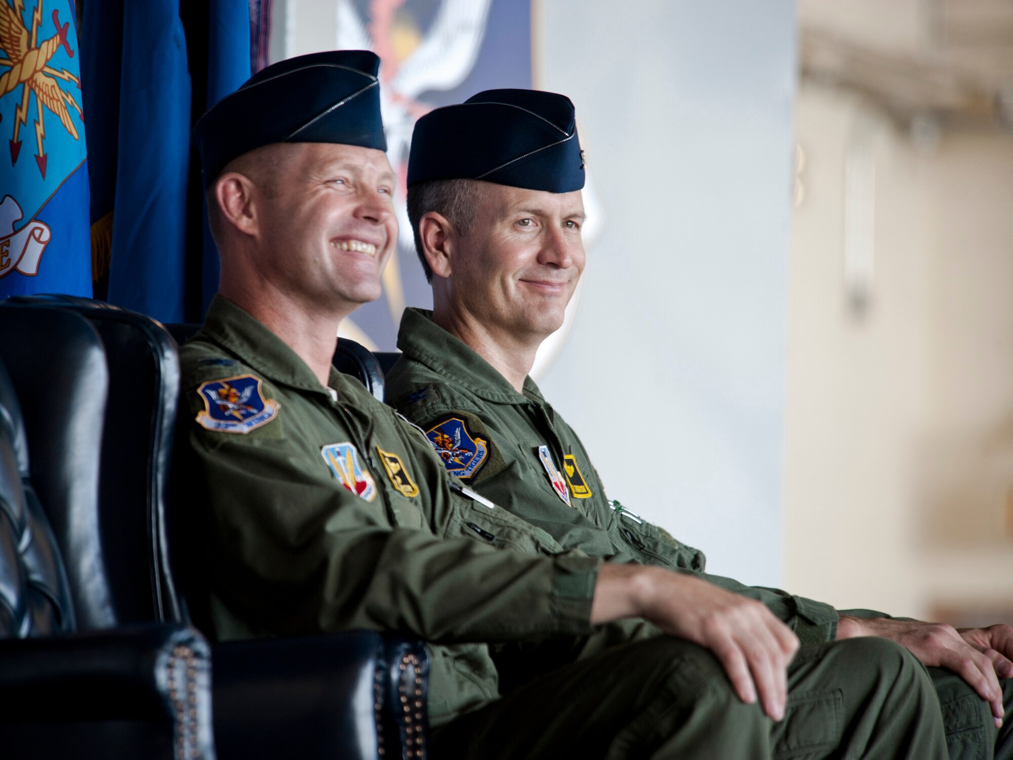 U.S. Air Force Col. Gary Henderson, 23rd Wing commander (left), and Col. Billy Thompson, incoming 23rd WG commander, share smiles during a change of command ceremony at Moody Air Force Base, Ga., July 19, 2011. As Thompson arrives from Davis-Monthan Air Force Base, Ariz., where he served as 563rd Rescue Group commander, Henderson will depart to Ramstein Air Base, Germany, where he will serve as 3rd Air Force deputy commander. (U.S. Air Force photo by Staff Sgt. Jamal D. Sutter/Released)