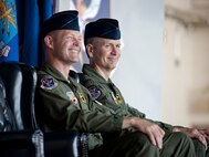 U.S. Air Force Col. Gary Henderson, 23rd Wing commander (left), and Col. Billy Thompson, incoming 23rd WG commander, share smiles during a change of command ceremony at Moody Air Force Base, Ga., July 19, 2011. As Thompson arrives from Davis-Monthan Air Force Base, Ariz., where he served as 563rd Rescue Group commander, Henderson will depart to Ramstein Air Base, Germany, where he will serve as 3rd Air Force deputy commander. (U.S. Air Force photo by Staff Sgt. Jamal D. Sutter/Released)