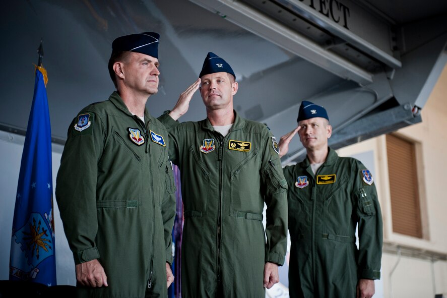 U.S. Air Force Col. Gary Henderson, 23rd Wing commander (center), and Col. Billy Thompson, incoming 23rd WG commander, salute Maj. Gen. Stephen Hoog, 9th Air Force commander, during the playing of Ruffles and Flourishes during a change of command ceremony at Moody Air Force Base, Ga., July 19, 2011. During the ceremony, Henderson relinquished command of the wing to Thompson. (U.S. Air Force photo by Staff Sgt. Jamal D. Sutter/Released)