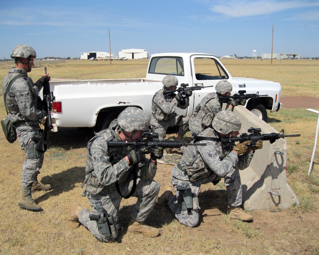 ALTUS AIR FORCE BASE, Okla. -- The Air Mobility Command Rodeo team from the 97th Security Forces Squadron practices tactical team movements July 17, 2011 at an outdoor training area behind the flightline. The AMC Rodeo is a biennial competition hosted by the AMC and will take place at Joint Base Lewis-McChord, Wash. July 24-29. The international competition focuses on improving worldwide air mobility forces' professional core abilities. (U.S. Air Force photo by 1st Lt. Cory Wagner / Released / 97th Air Mobility Wing Public Affairs)