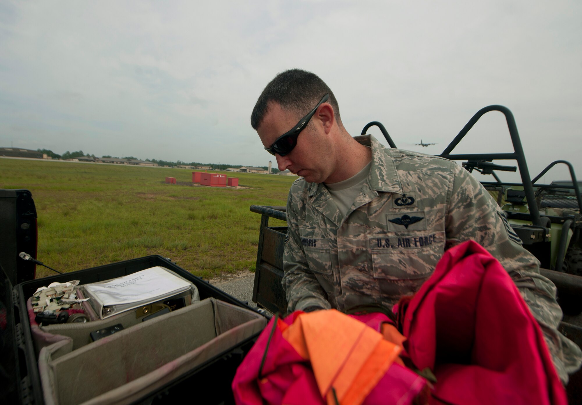 U.S. Air Force Tech. Sgt. Clayton Morris, 38th Rescue Squadron aircrew flight equipment NCO in charge, pulls out a landing mark in preparation for a free fall jump at Moody Air Force Base, Ga., July 12, 2011. The free fall jump happened out the back of an HC-130P Combat King during a training mission. (U.S. Air Force photo by Airman 1st Class Joshua Green/Released)
