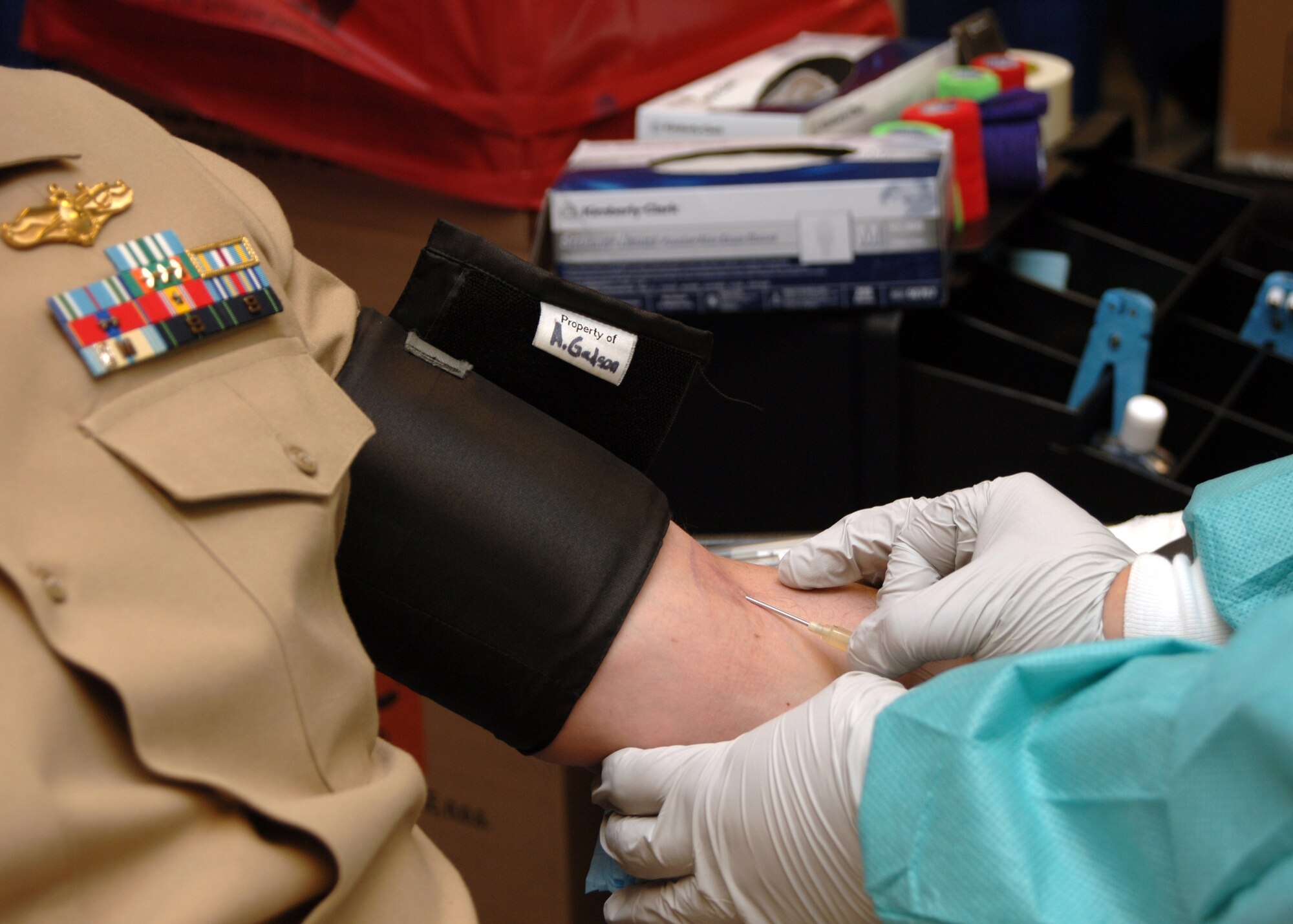A Sailor assigned to Navy Intelligence Reserve Region Washington donates blood in support of the Armed Services Blood Program on July 9.  The program provides quality blood products for servicemembers and their families in both peace and war. (U.S. Navy photo by Mass Communication Specialist 2nd Class Clifford L. H. Davis)