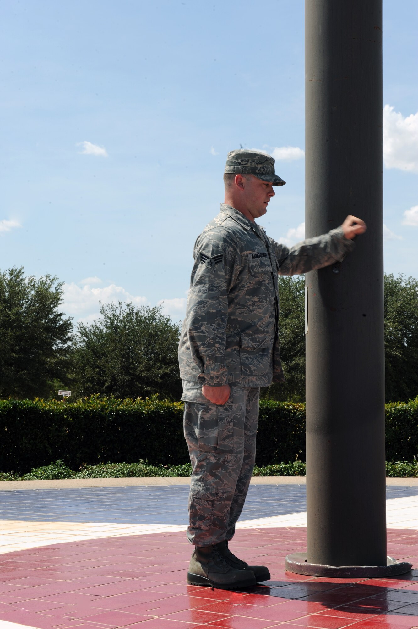 DYESS AIR FORCE BASE, Texas-- Dyess Honor Guardsman Senior Airman Zachary Montgomery lowers the flag during a retreat ceremony held at the parade grounds here July 15, 2011. A retreat ceremony signifies the end of a duty day. (U.S. Air Force photo by Airman 1st Class Courtney Moses/Released) 